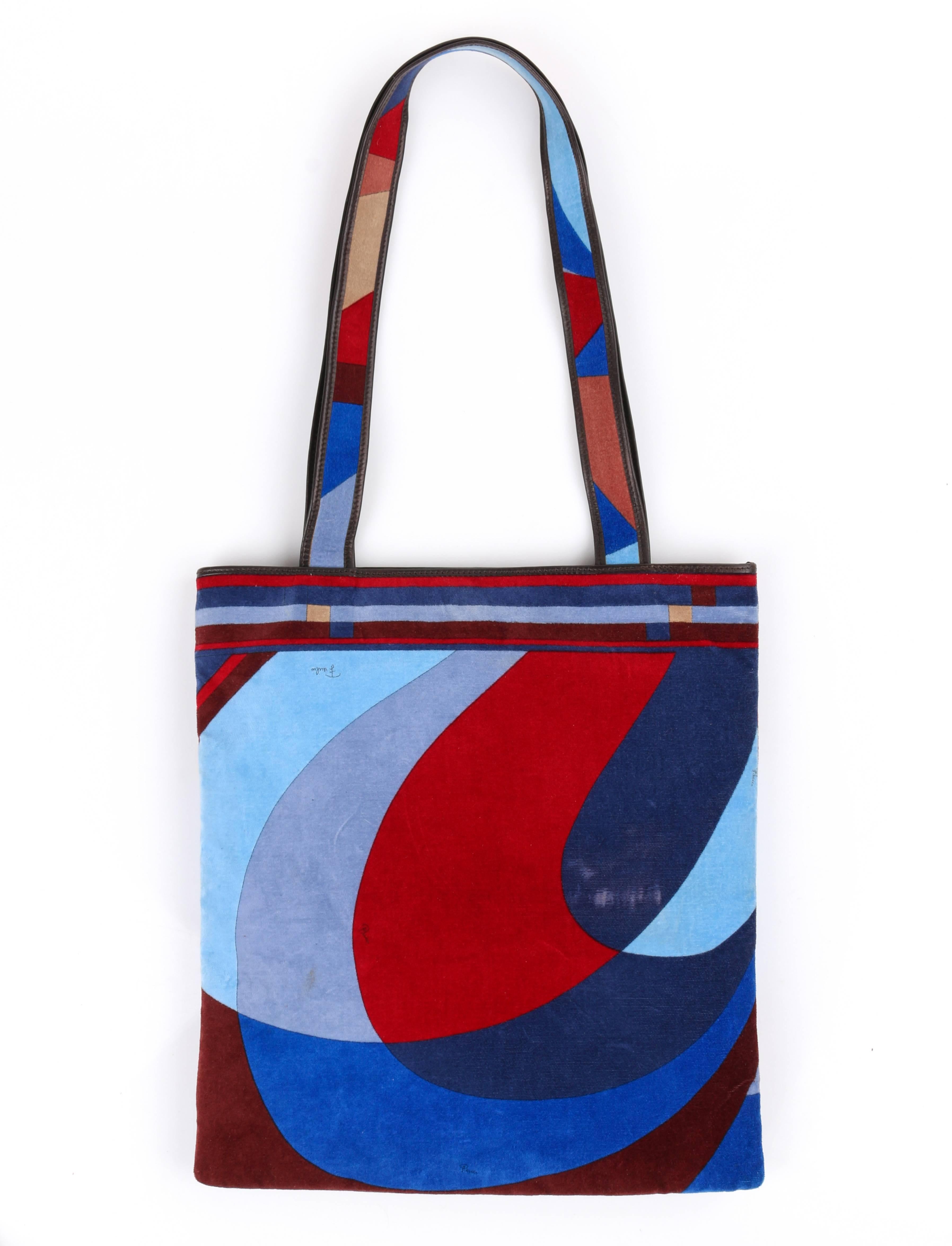 Vintage Emilio Pucci c.1970's blue multi-color geometric signature print velvet tote / handbag / purse. Rare style. Large multi-color geometric signature print velvet body in shades of burgundy, garnet red, blue, gray, and beige. Two flat shoulder