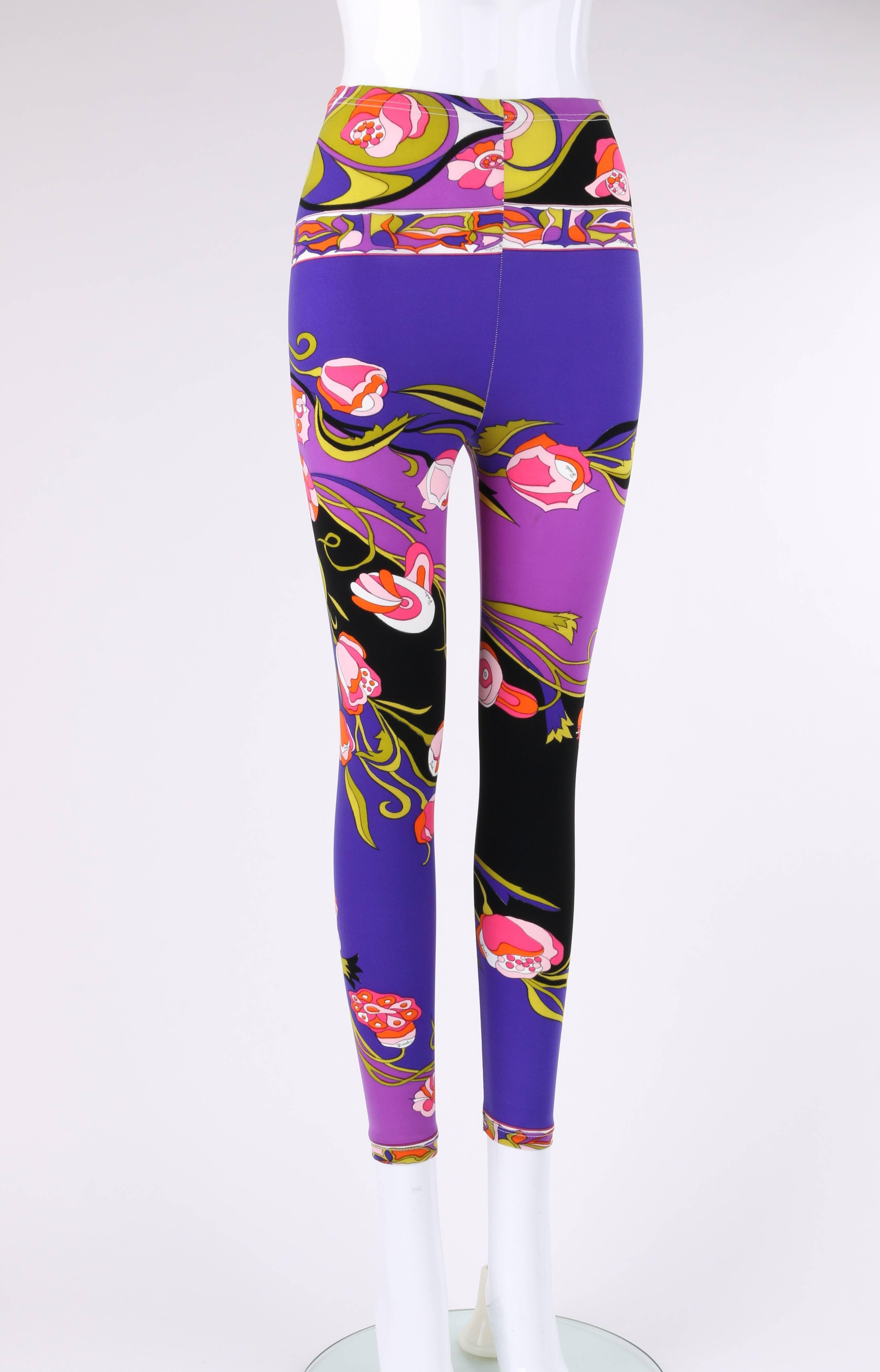 Vintage Emilio Pucci c.1970's purple multicolor floral signature print knit cropped leggings. Multicolor large floral signature print in shades of purple, blue, black, pink, orange, green, and white. Elastic waistband. High waisted. Cropped ankle