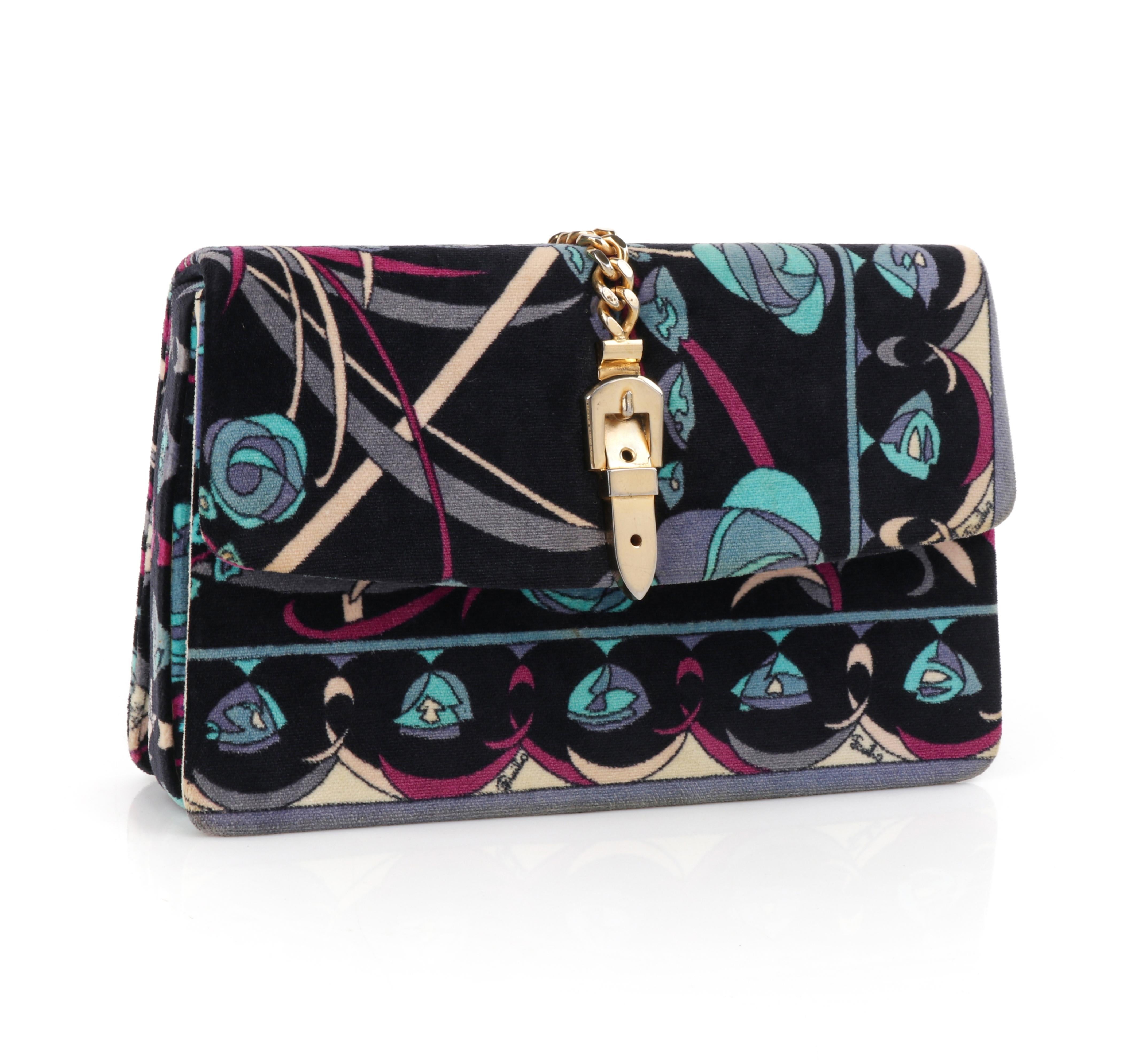 EMILIO PUCCI c.1970’s Velvet Geometric Floral Blue Fold Over Gold Chain Clutch
 
Brand / Manufacturer: Emilio Pucci
Circa: 1970’s 
Style: Clutch
Color(s): Shades of blue, purple, pink, and ivory
Lined: Yes
Unmarked Fabric Content (feel of): Low pile