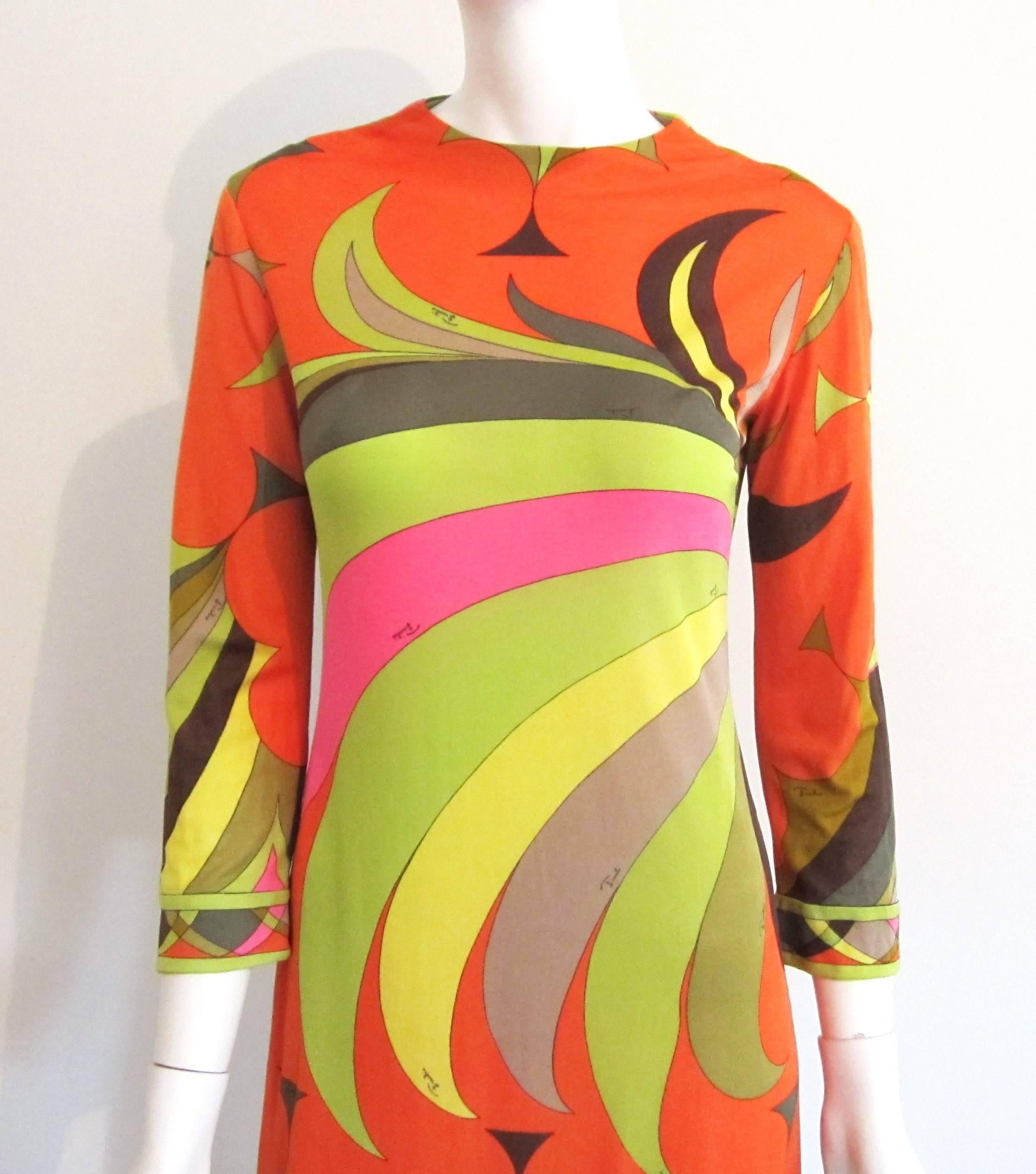 Stunning colors on this Fabulous Emilio Pucci Silk Dress. Vibrant Orange, green, yellow, brown and pink. Zippered back. Just stunning! Labeled a size 10, however vintage sizing does NOT equal today's sizing. Please refer to the measurements. This