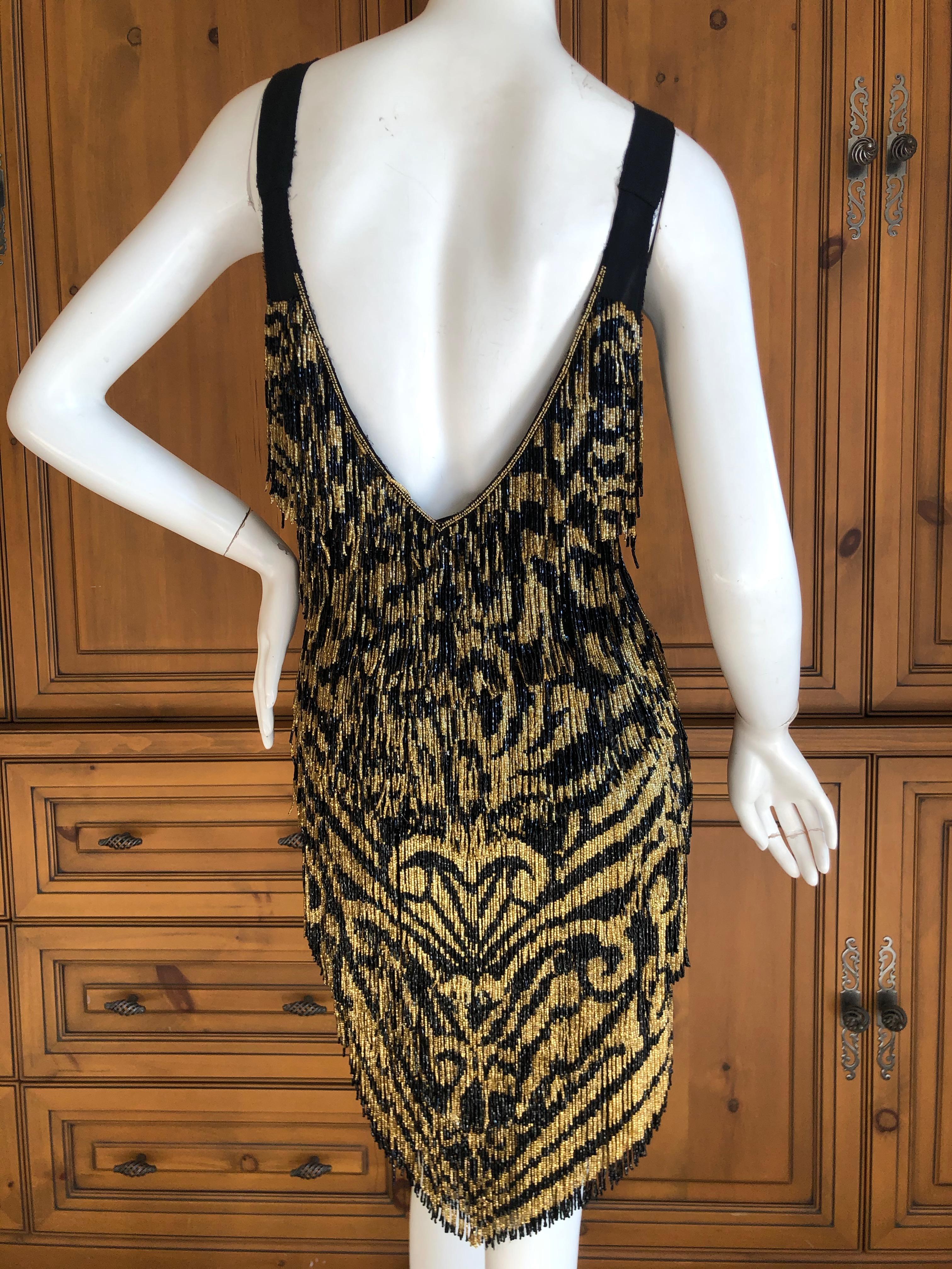Emilio Pucci Flapper Style Black & Gold Beaded Fringe Mini Dress.
 WOW , this is so fun. 
These are glass beads, and this weighs a lot, so not for the faint of heart.
Size 40 / 6 US
 Bust 35