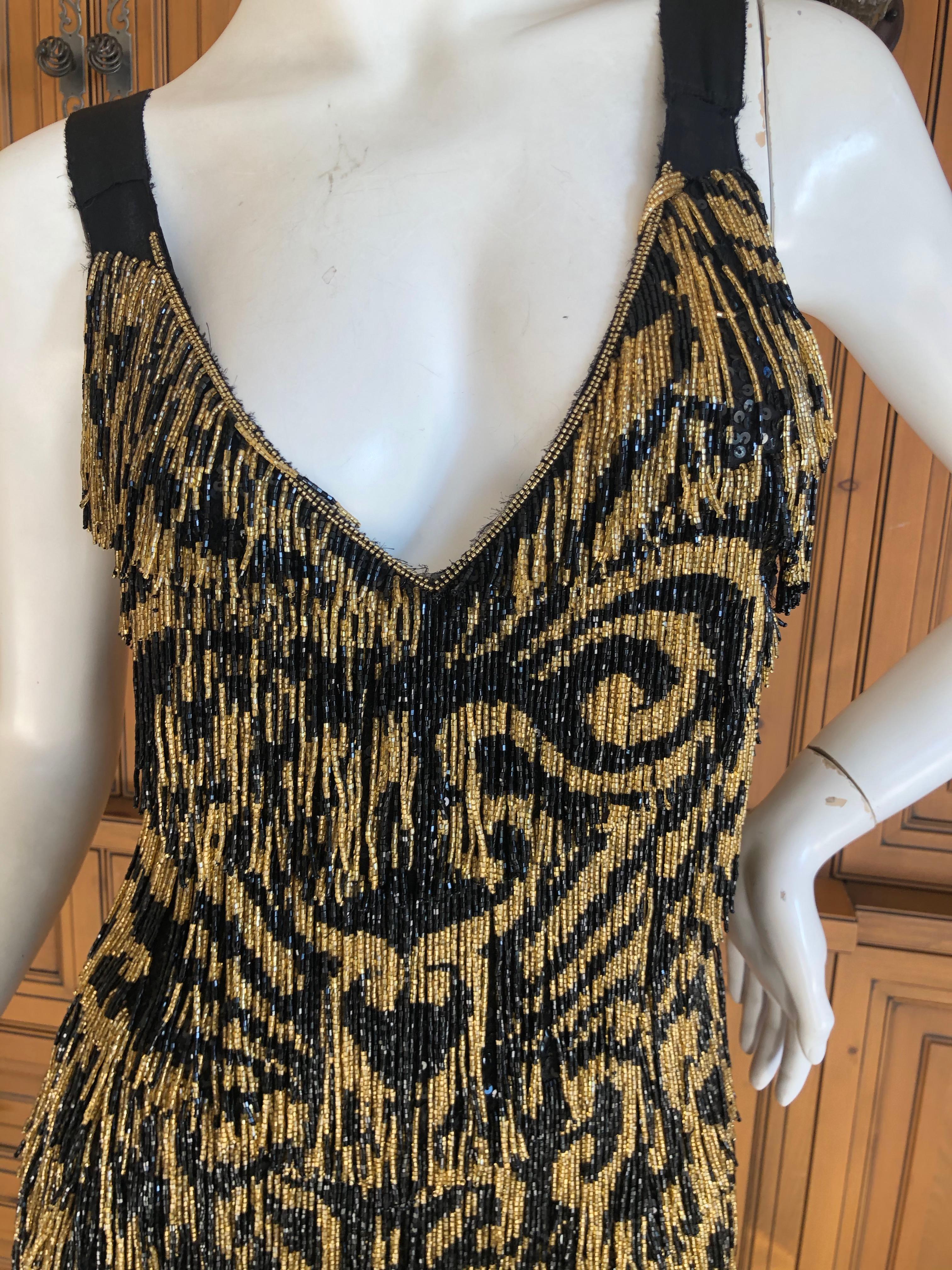 Emilio Pucci Flapper Style Black & Gold Beaded Fringe Mini Dress.
 WOW , this is so fun. 
These are glass beads, and this weighs a lot, so not for the faint of heart.
Size 40 / 6 US
 Bust 35