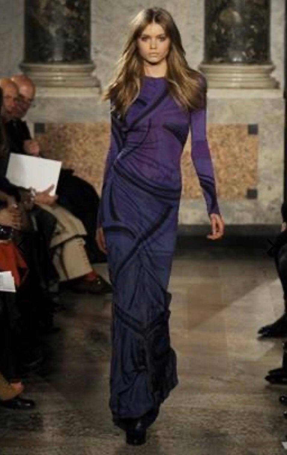 All eyes on you in this Pucci gown! From Peter Dundas 2010 Fall Ready-to-Wear collection, this floor length mermaid gown features long sleeves and a key hole open back. Electric purple ombre to grey/blue with the iconic pucci print. 
Size 36 Italian