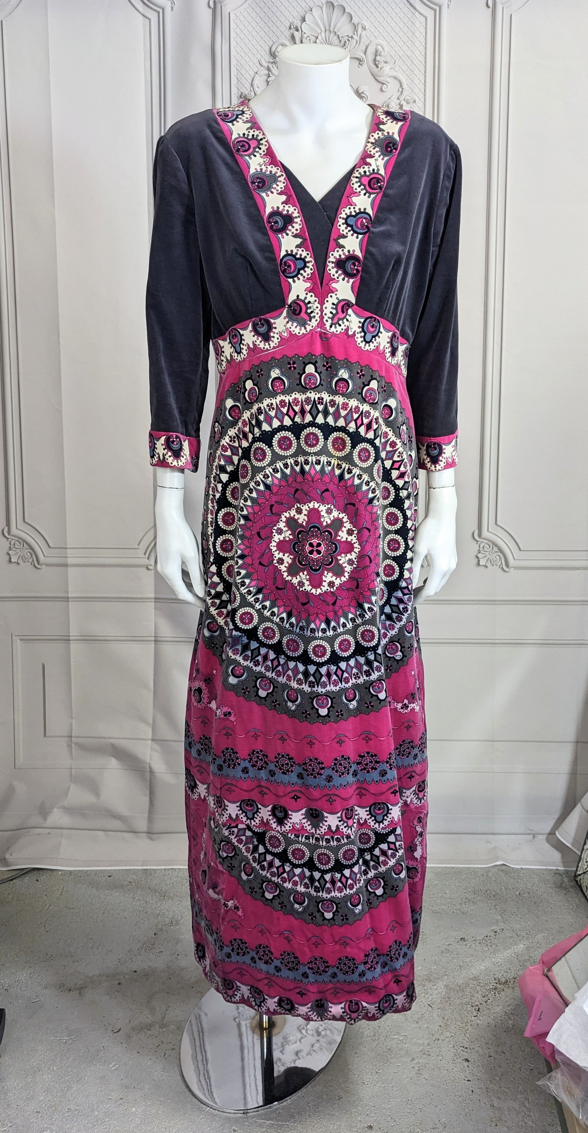 Elegant Emilio Pucci Graphic Velvet Gown from the 1970's. Placed print in cotton velvet on a fully silk lined A line maxi dress. 
Faux wrap Empire line with full A line skirt falling below and 3/4 sleeves. There are 2 gray period velvet modesty