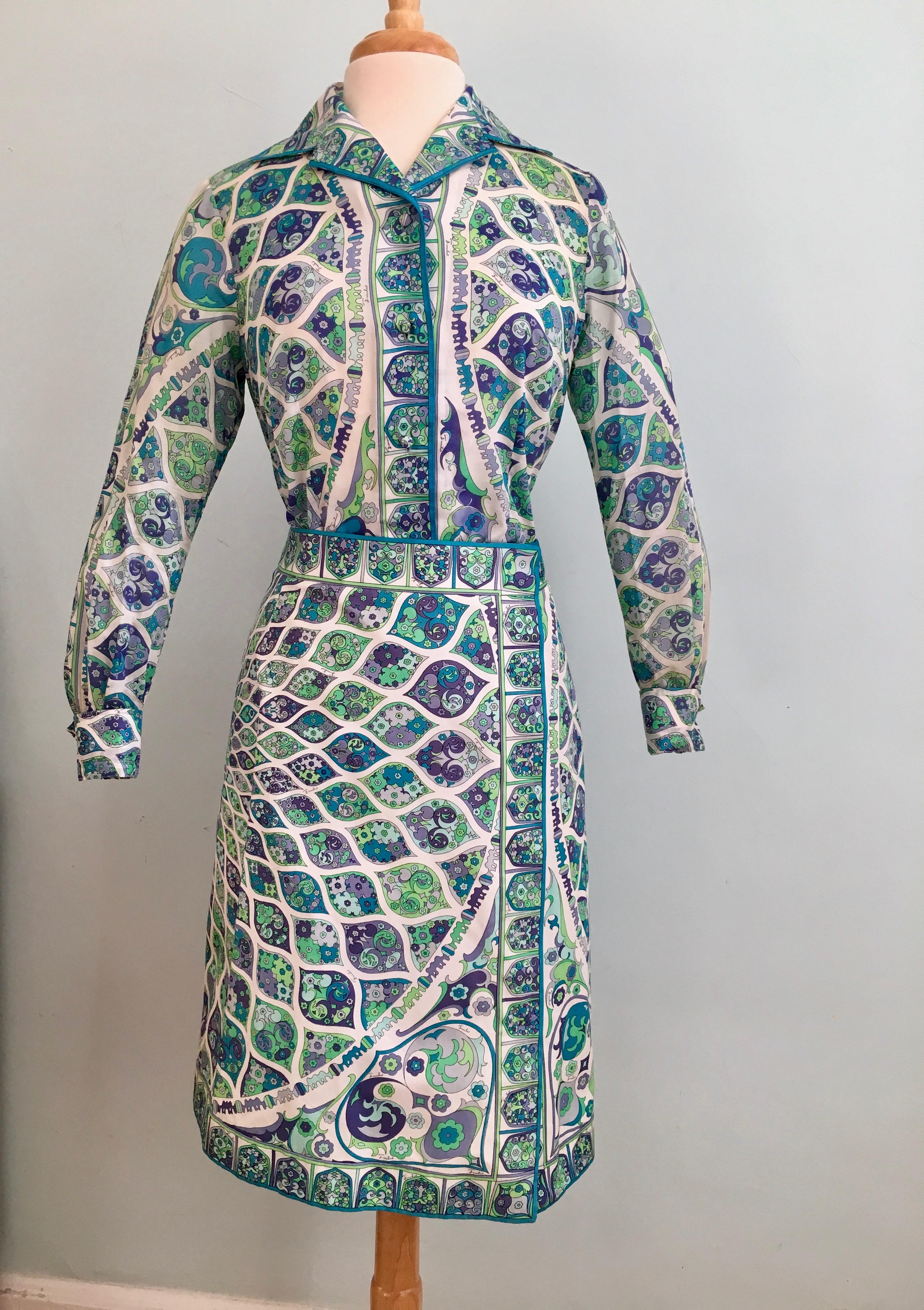 1960s Emilio Pucci lightweight cotton blouse and A-line skirt set.  Features vibrant green, lavender, blue and purple allover Pucci print with the Pucci signature throughout the print. The blouse is made out of a lightweight voile cotton and buttons