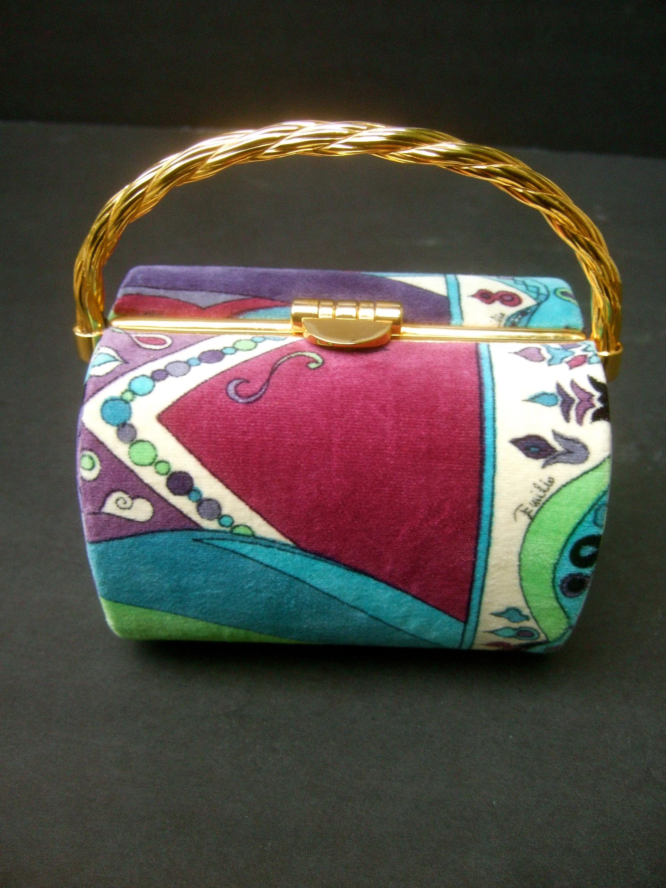 Emilio Pucci Iconic pastel velvet box purse c 1970
The luxurious barrel cylinder-shaped handbag is covered with Pucci's 
plush pastel velvet print. Emilo's script name is concealed within the  
the vibrant velvet print covering

Adorned with a sleek