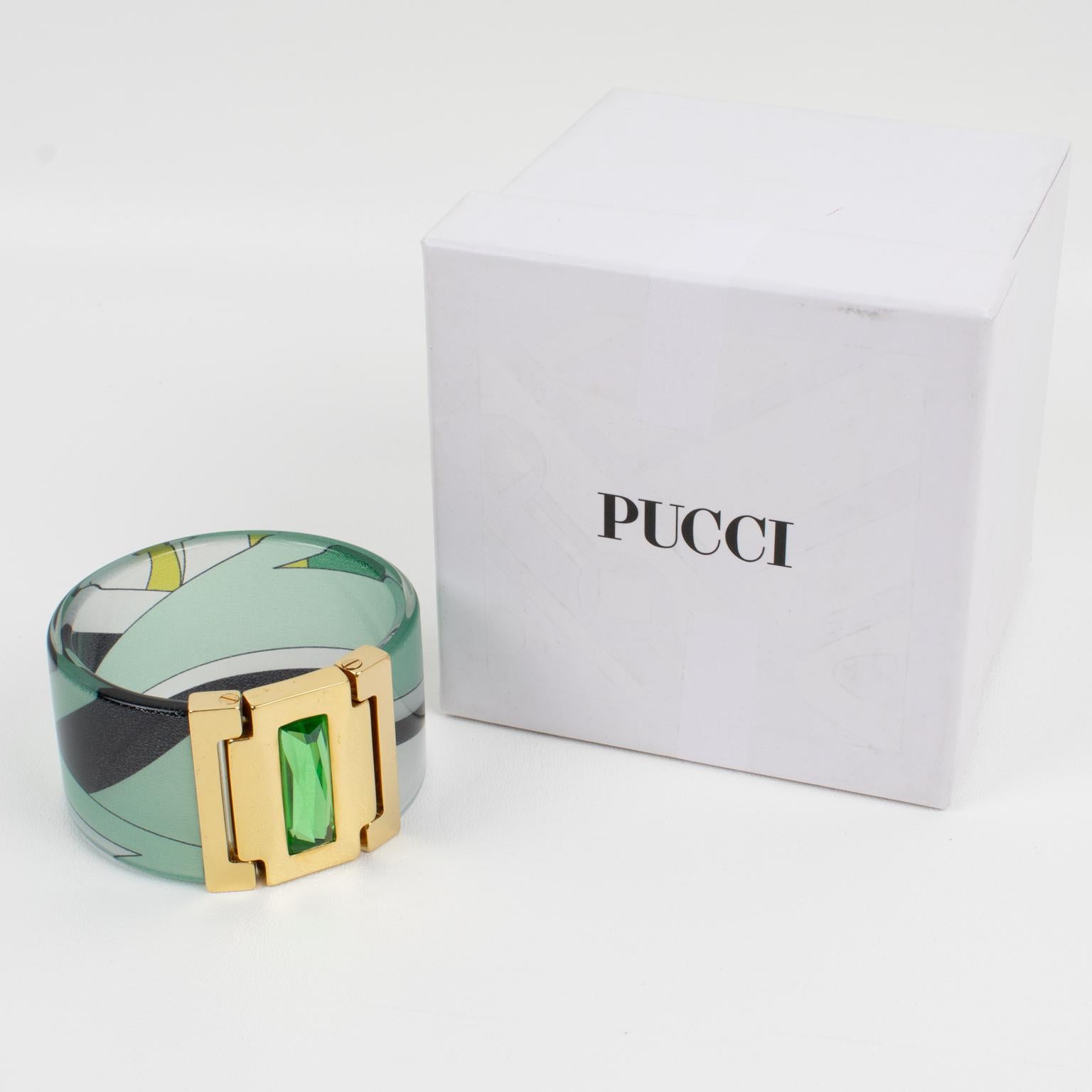 Emilio Pucci designed this lovely gilded metal, acrylic, and silk bracelet bangle. The massive bangle shape boasts a clear acrylic band with multicolor Pucci silk inclusion in emerald green, avocado green, black, and white colors. The bracelet