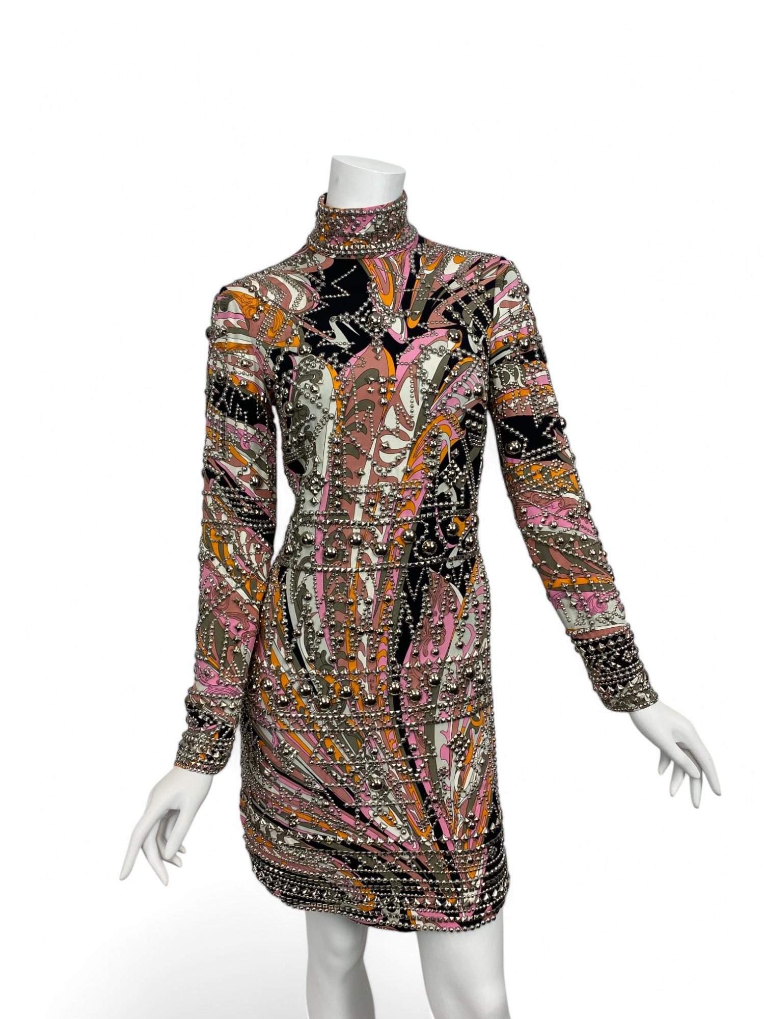 From Peter Dundas’s dynamic Fall/Winter 2014 collection for Emilio Pucci, this striking long-sleeve dress channels the brand’s signature sensuality with a refined, modern edge. Crafted from fluid black silk, the design features a sleek high neckline