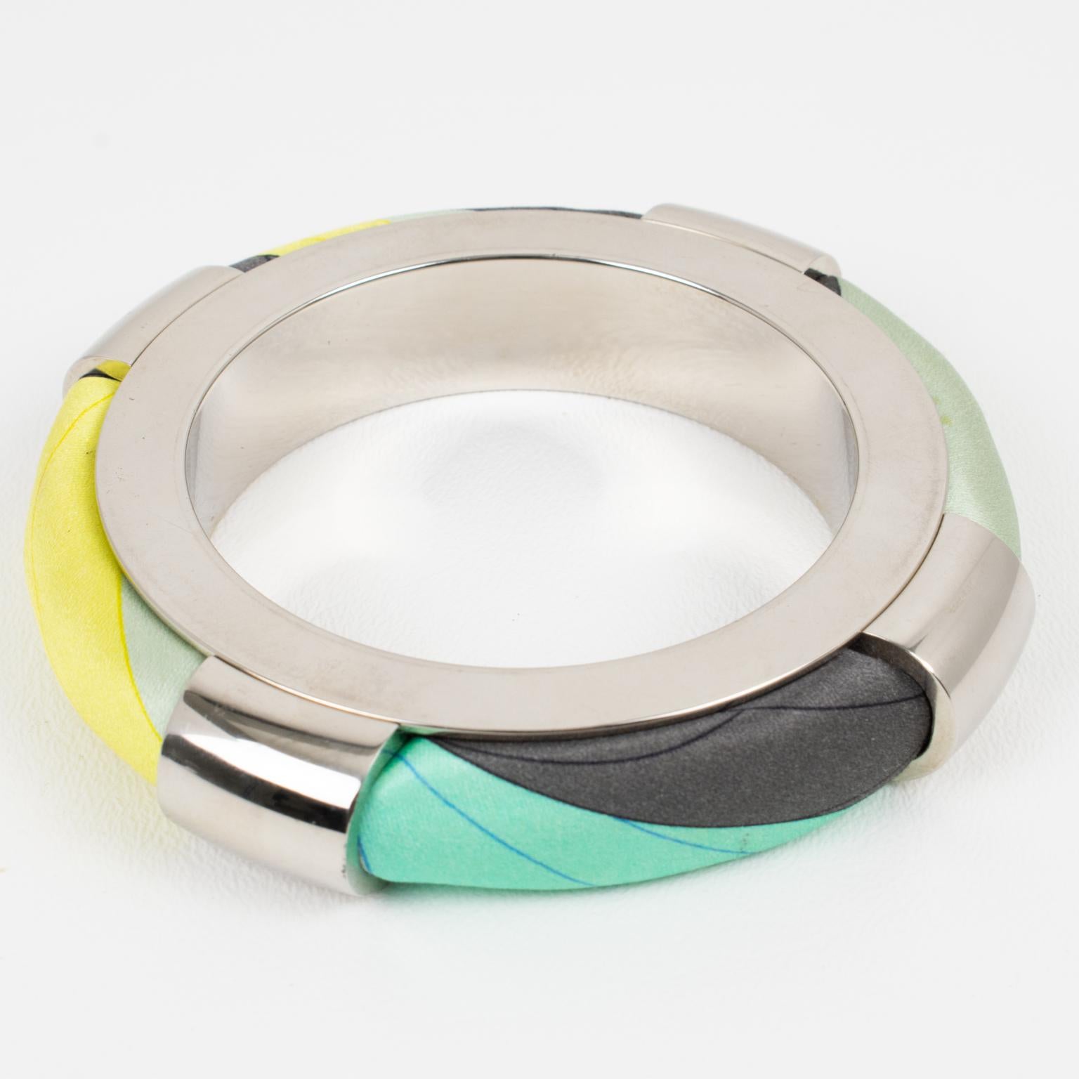 Emilio Pucci, Italy, designed this stunning chunky chromed metal and silk bracelet bangle. The abstract design features a massive chromed metal framing with multicolor silk elements. Emilio Pucci's signature silk abstract fabric is encased into it.