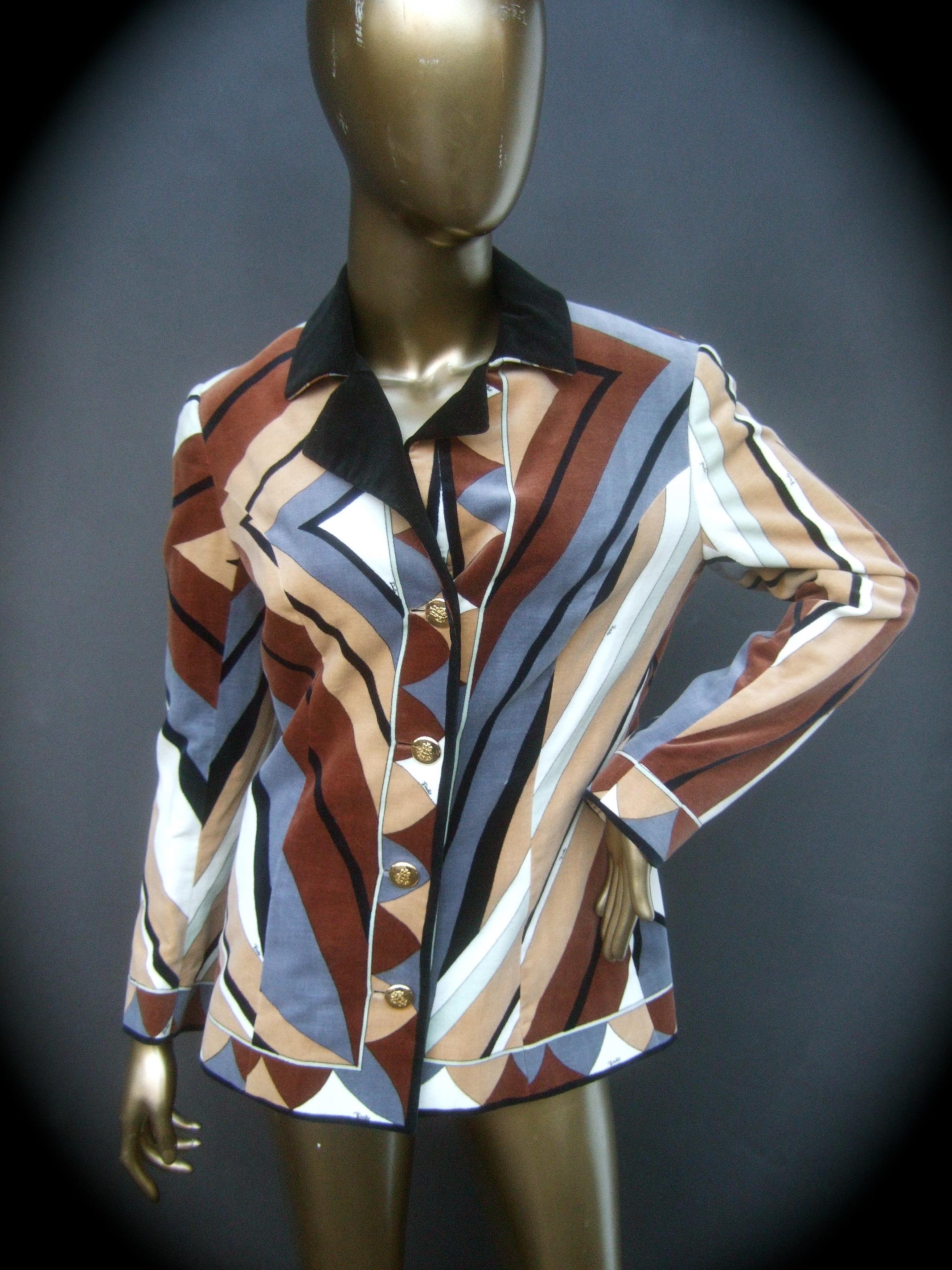 Emilio Pucci Mod cotton velvet print Italian jacket c 1970
The plush cotton velvet jacket is illustrated with a collage of linear and geometric graphic designs in earth tone hues. Emilio's script name is scattered throughout the bold graphic print
