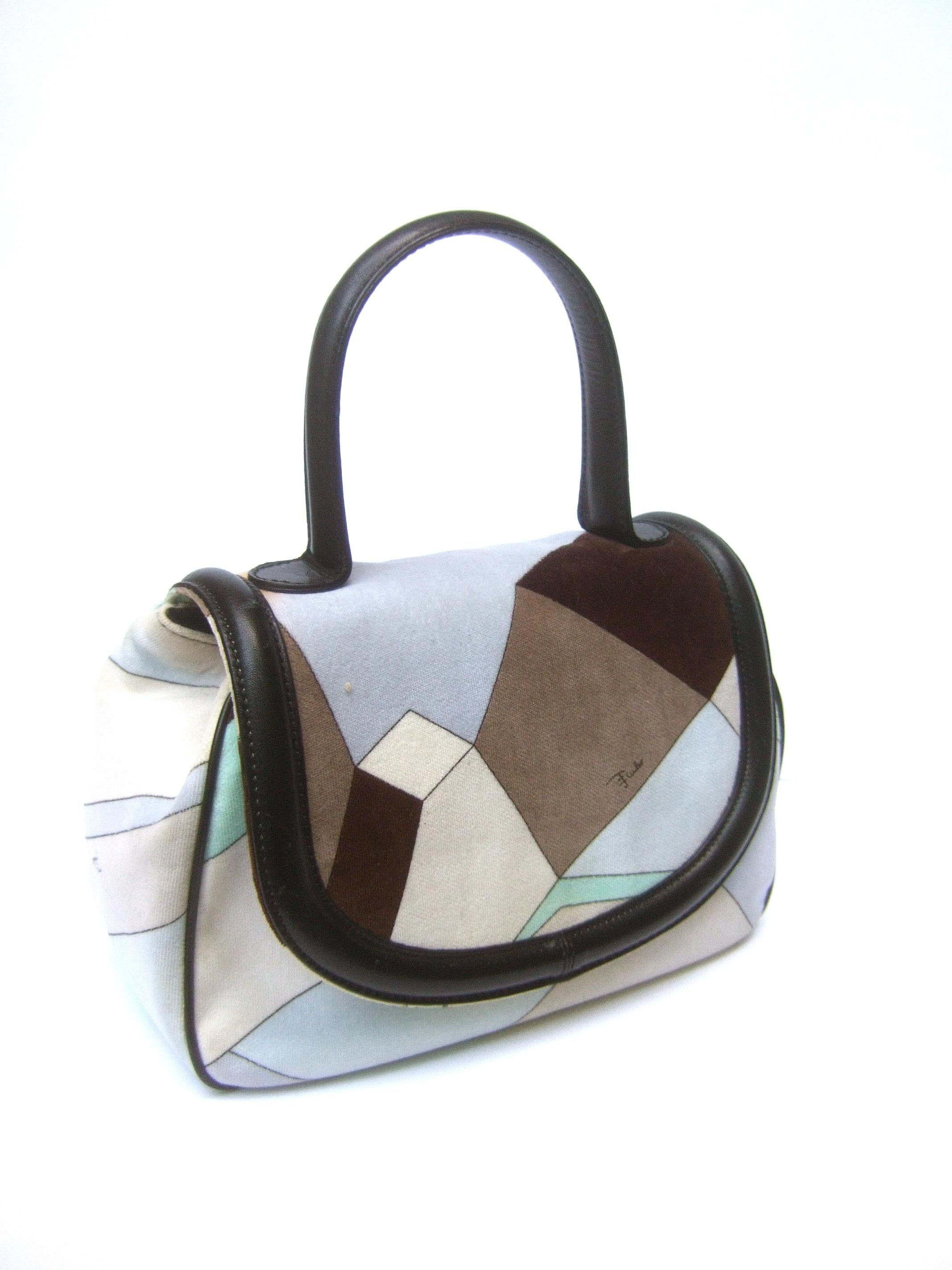 Emilio Pucci Mod velvet print leather trim Italian handbag circa 21st c 
The stylish Italian handbag is covered with bold geometric graphic
designs in a myriad of colors; pale blue, aqua blue, mocha & chocolate
brown

The handle is constructed with