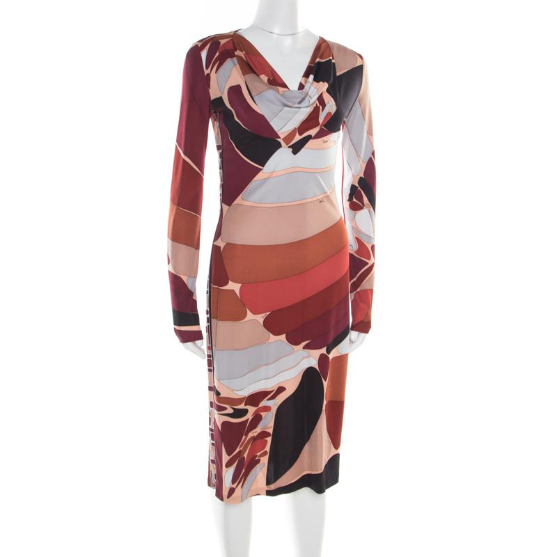 Glamorously stunning is this Emilio Pucci dress! The multicolour creation is made of 100% silk and features an abstract print all over it. It flaunts a cowl neck and long sleeves. Pair it with pointed stilettoes and a top handle bag to rock a