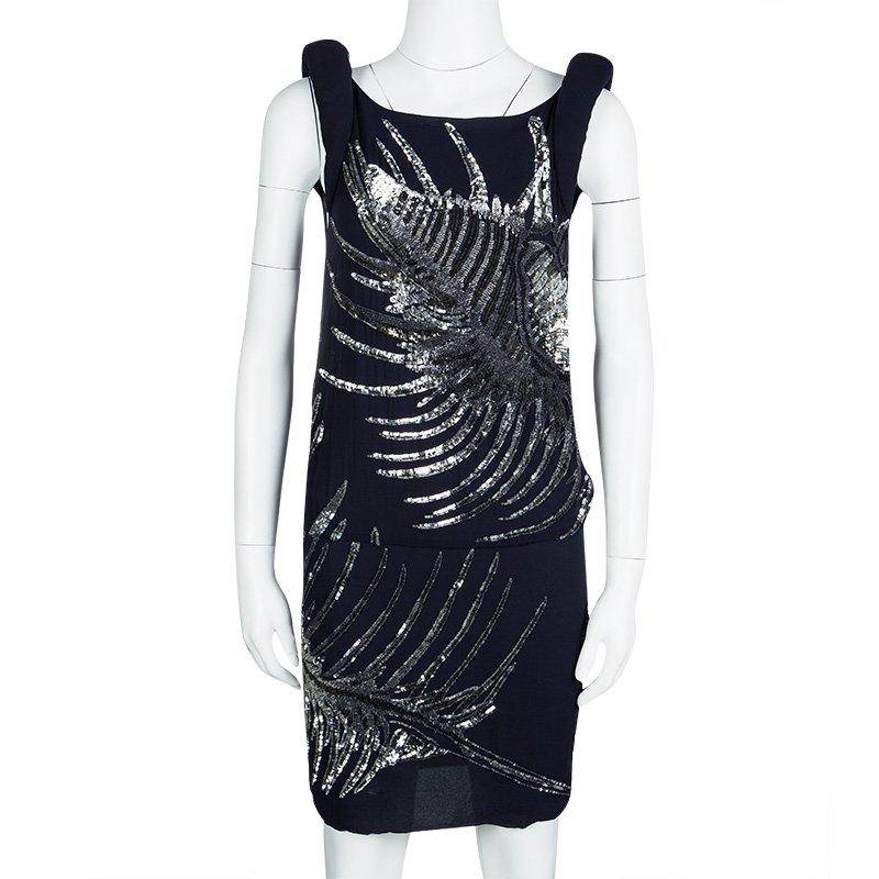 This pretty sleeveless dress is by Emilio Pucci. Made from silk, this dress has a boat neck, and sequin embellishments all over. It also flaunts a drop waist style that gives the dress a gorgeous silhouette. A cute pair of ballet flats or strappy