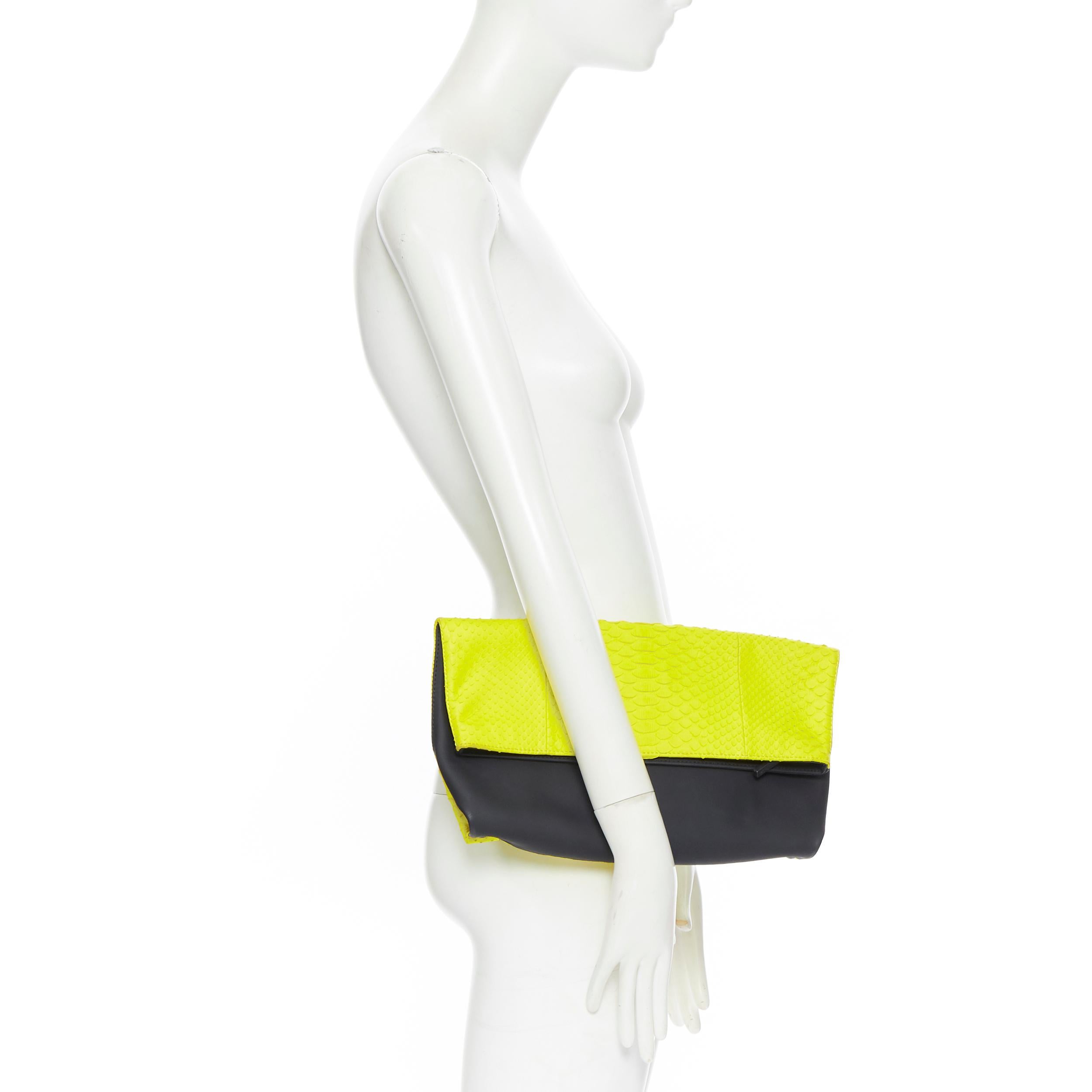 EMILIO PUCCI neon yellow scaled pleather black rubber fold over clutch bag 
Brand: Emilio Pucci
Designer: Emilio Pucci
Model Name / Style: Foldover clutch
Material: Leather, PVC
Color: Yellow, black
Pattern: Solid
Closure: Zip
Extra Detail: Top zip
