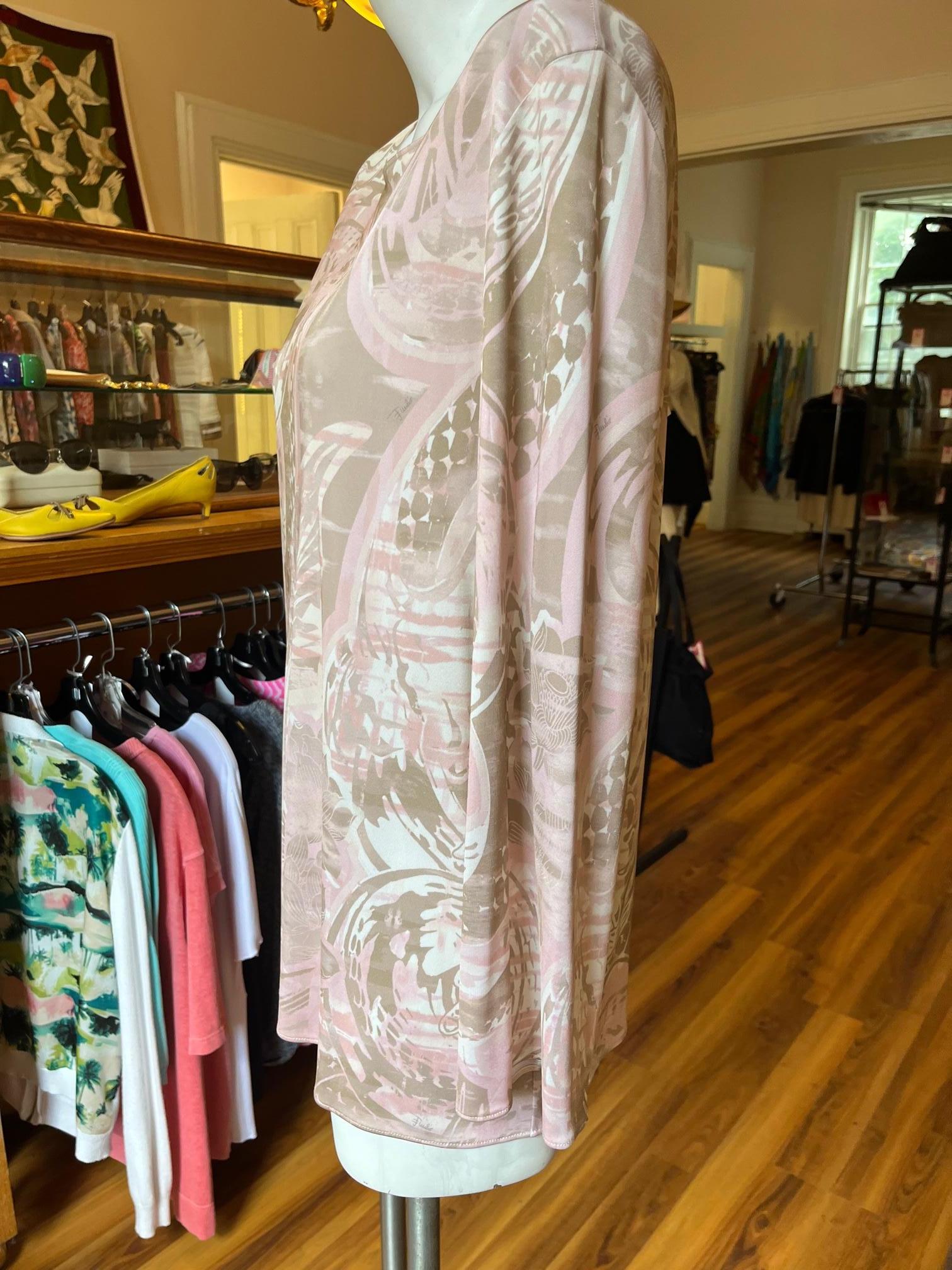 This is lovely Emilio Pucci new with tag tunic with very muted colors for Pucci. It has a round collar as well as long sleeves.
Emilio Pucci pieces tend to be bold and colorful, and this tunic is one of the exceptions.
The tunic is made in Italy of