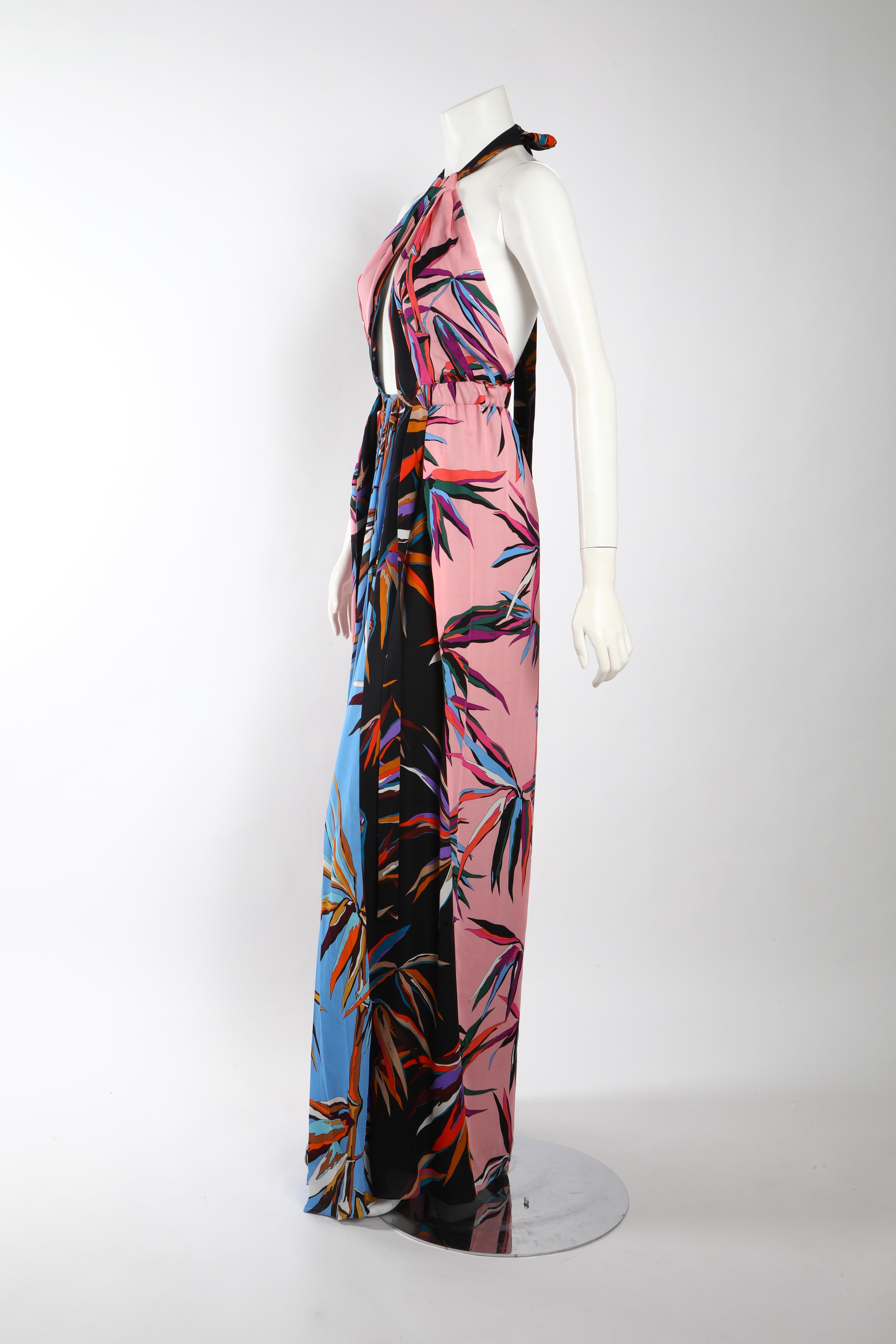 Printed floor length gown in tones of pastel pink, sky blue, and navy by Emilio Pucci. Draped silhouette with keyhole opening above the bust line and halter neck tie. Size US 2/ IT 38. 