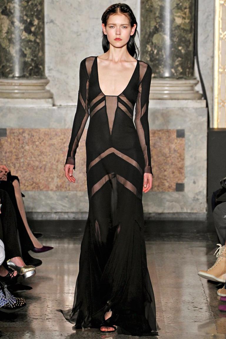 Emilio Pucci showstopping sexy sheer black gown.   Fashioned of silk in a  bias cut silhouette; with godet panels extending into raw cut edges at lower hemline. Additionally boasts, strategically placed panels throughout the garment.   Fully lined.