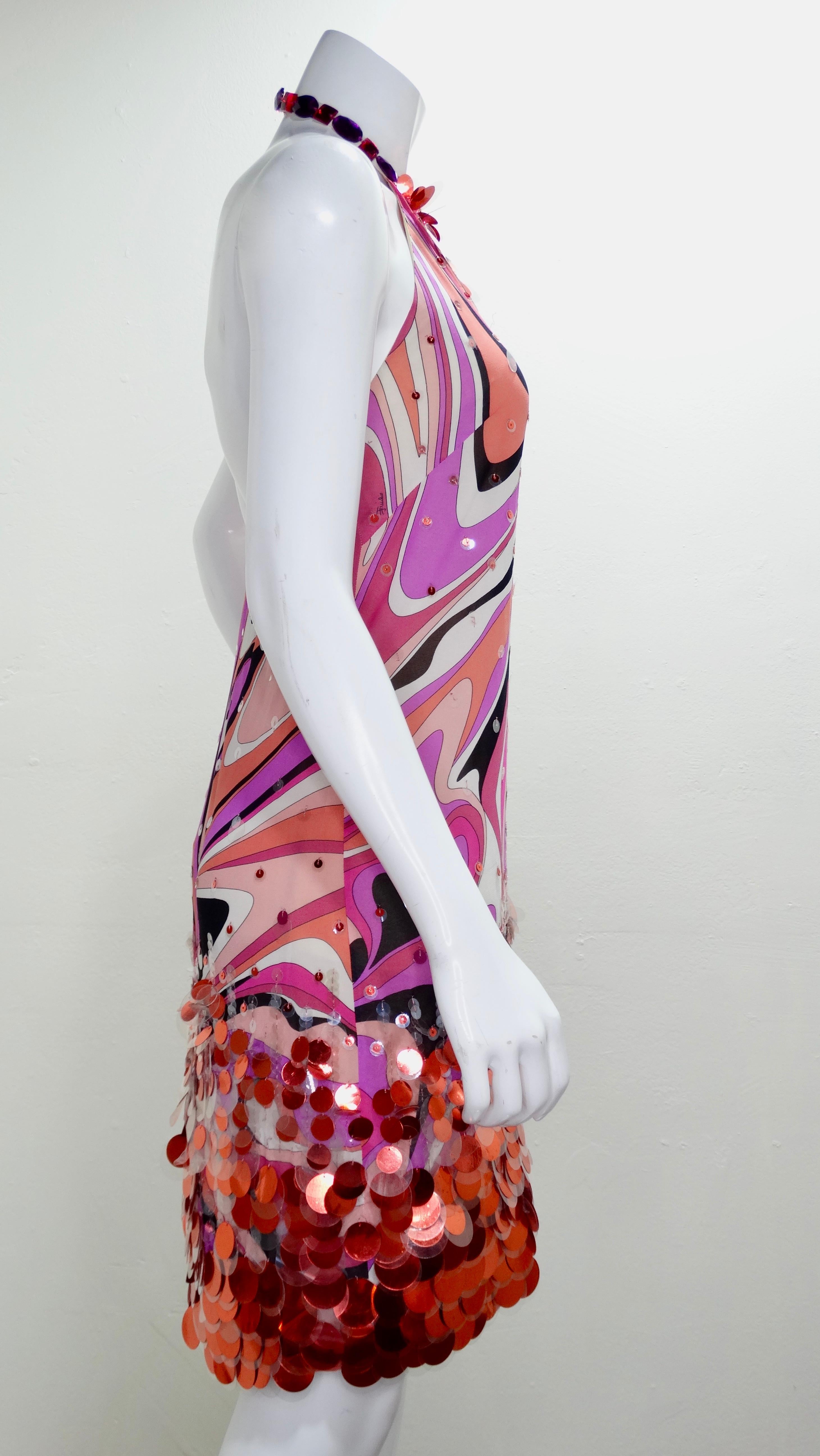 Show off in this Pucci day or night! Circa early 2000s, this Pucci mini dress features one of Pucci's signature abstract motifs in pinks, purple, white and black. Featured at the bottom are clear and pink sequins with an embellished halter top. A