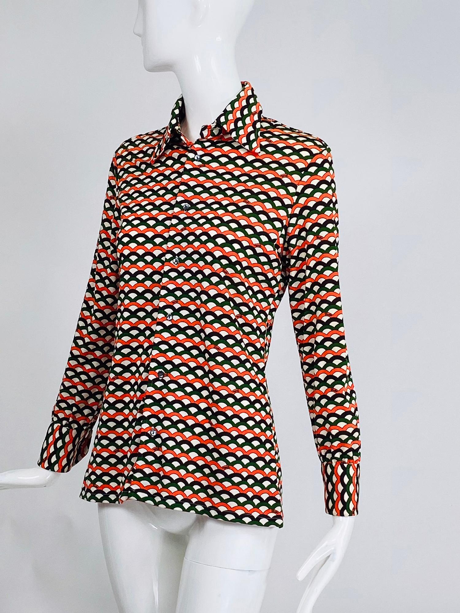 Emilio Pucci signed geometric print shirt from the 1970s. Long sleeve button front wing collar shirt, Charlie's Angels style in orange, white, black and green. Fitted shirt done in silky polyester. Marked size 10, fits like a size 4.
     In