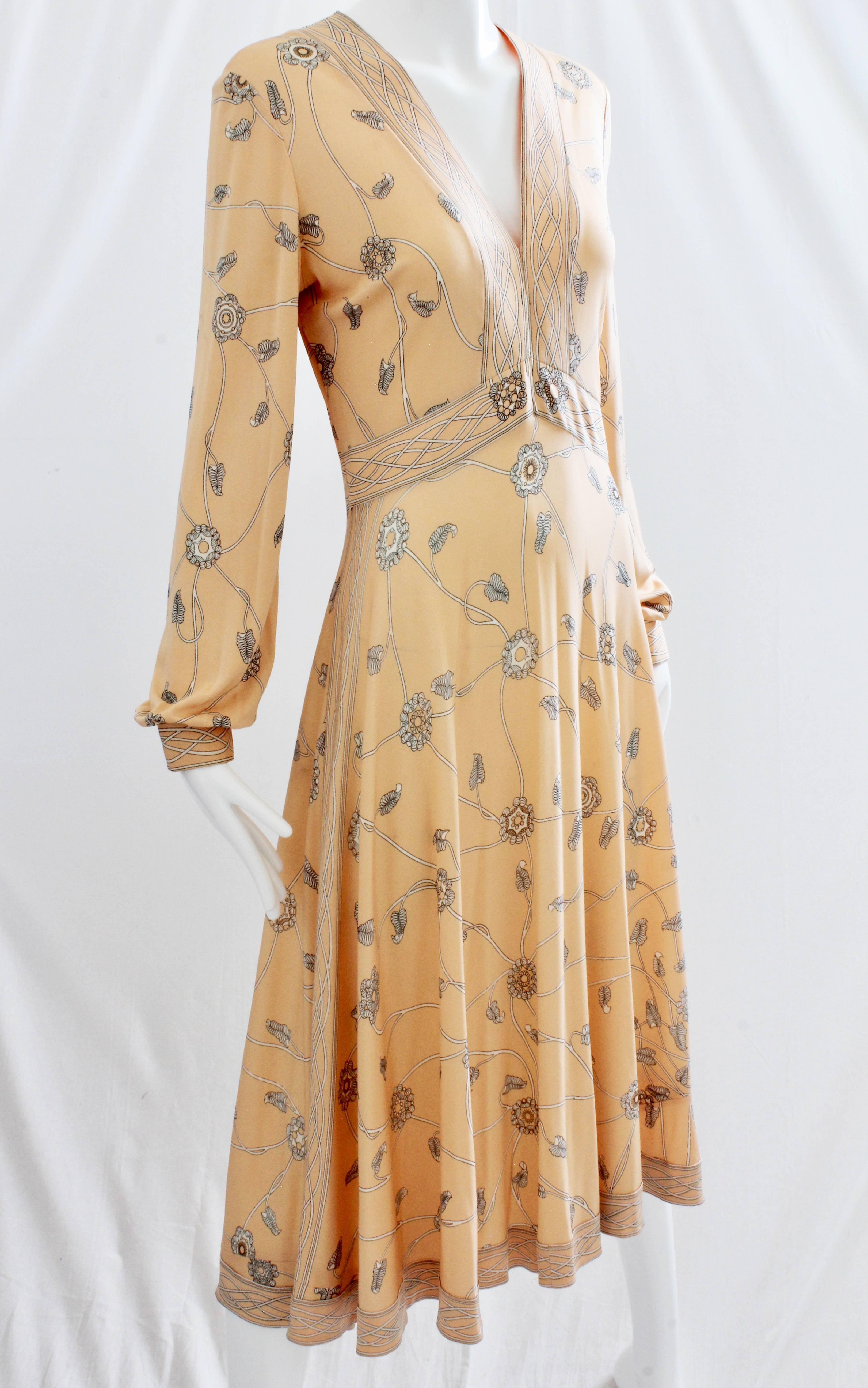 Here's one gorgeous silk jersey dress from Emilio Pucci, likely made in the late 1960s or early 70s. It features bishop sleeves and cinched waist, and fastens with a hidden zipper under the wearers left arm. In excellent condition for its age, we