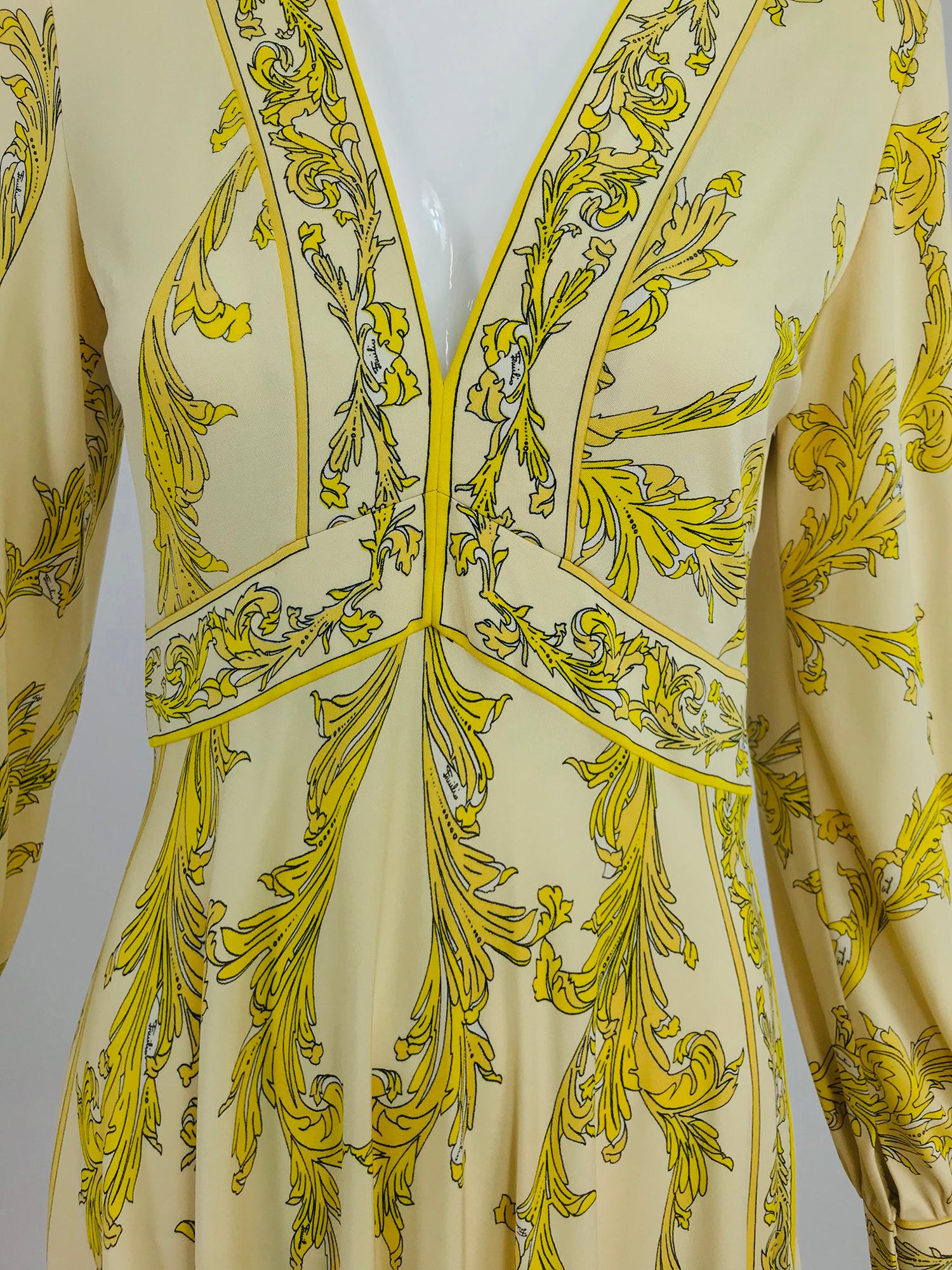 Emilio Pucci Silk jersey Print V Neck Dress from the 1970s. Silk jersey in shades of yellow against a champagne background, black outlines the design. Banded V neckline with a high banded waist, long sleeves have banded cuffs that close with hidden