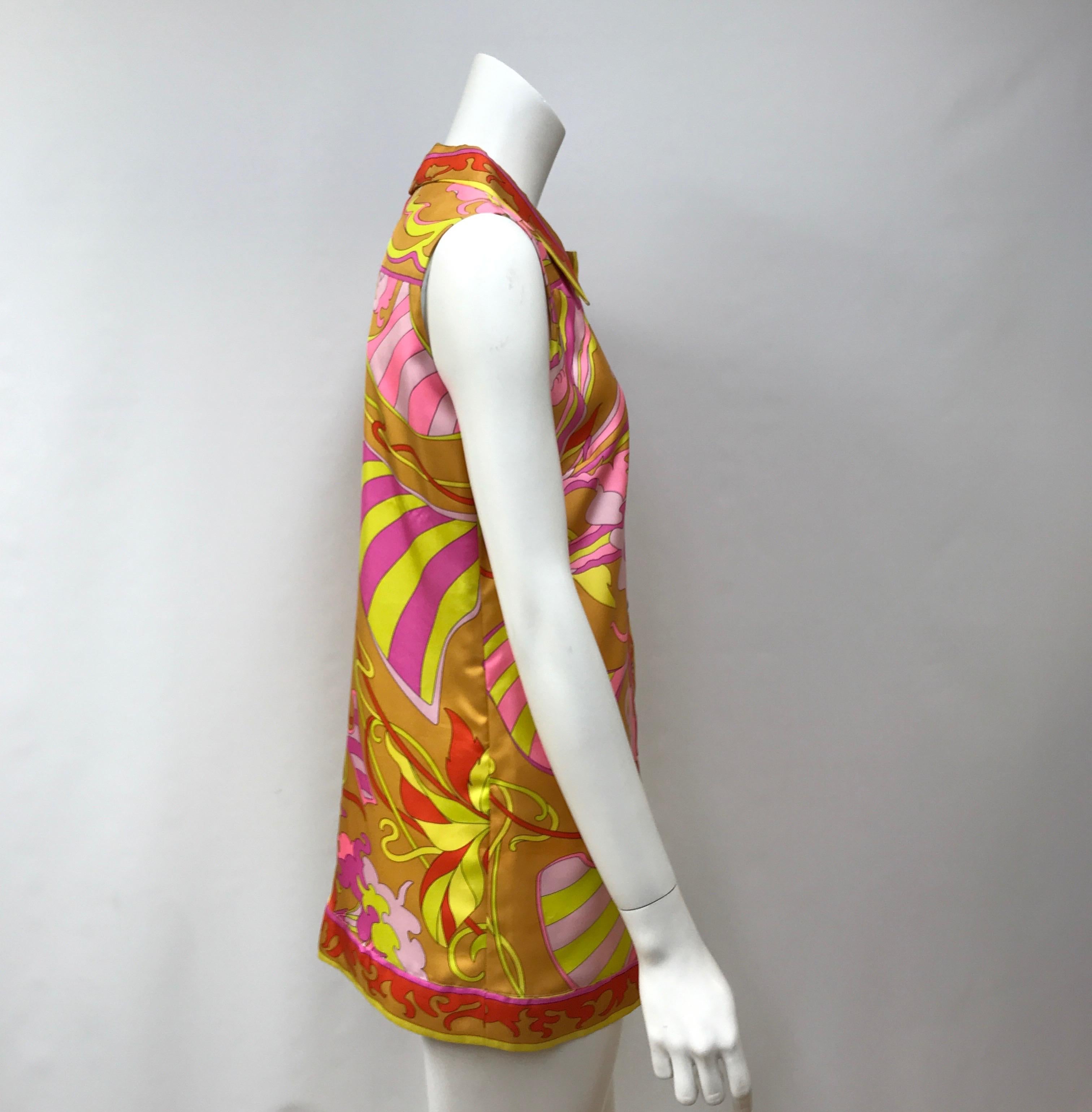 Emilio Pucci Silk Orange, Yellow, and Pink Button Down Top-42. This amazing Emilio Pucci top is in excellent condition, it has minimal signs of use. The top is made of silk throughout and has an abstract design with orange, yellow, and pink colors.