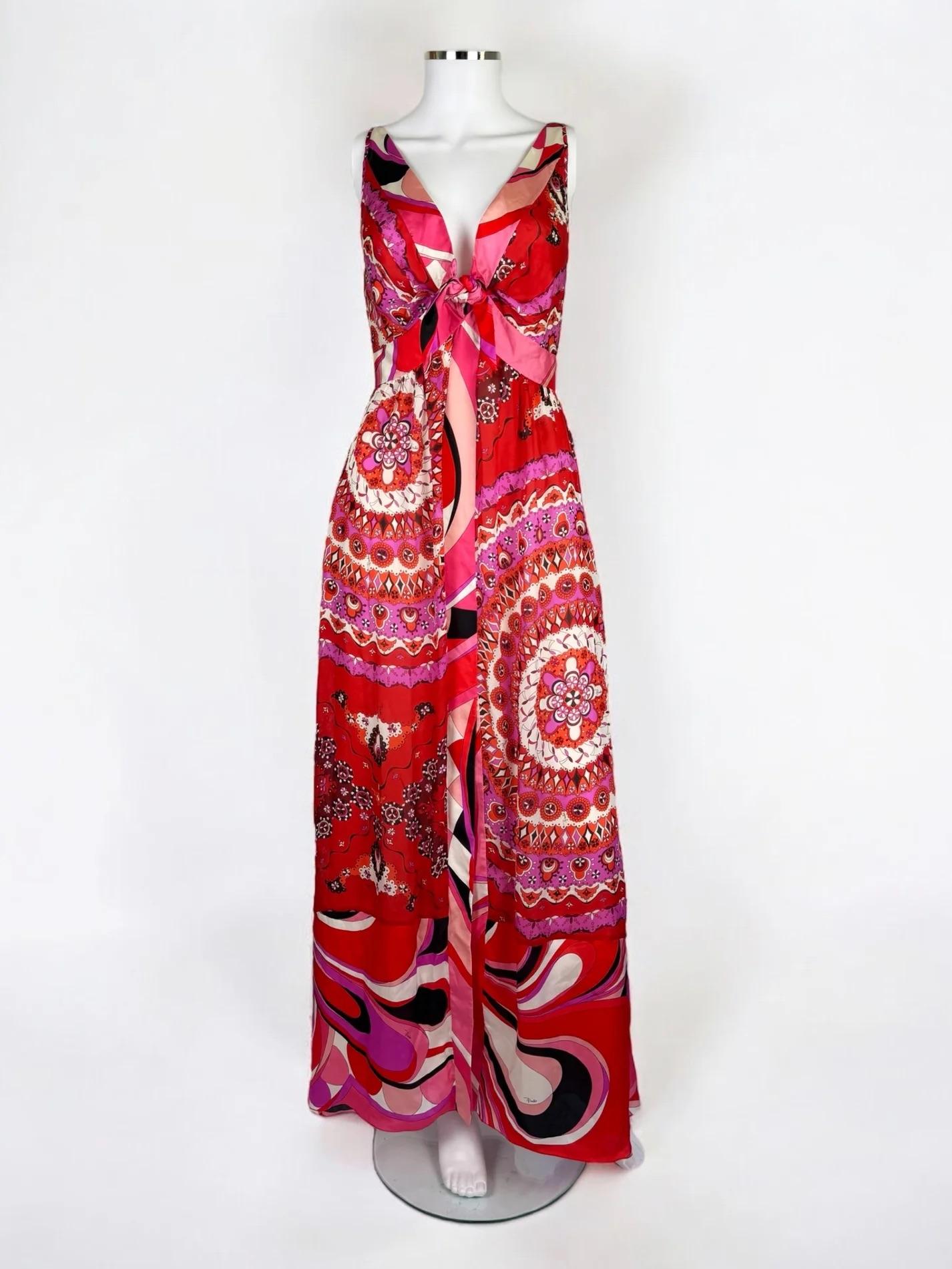 Emilio Pucci printed silk gown, Spring Summer 2012
Plunging neckline which secures with a bow
Combines several prints from the SS12 collection in a combination of bright reds, pinks and purple
Lined in nude silk
Slit at front
Back zip
Very good