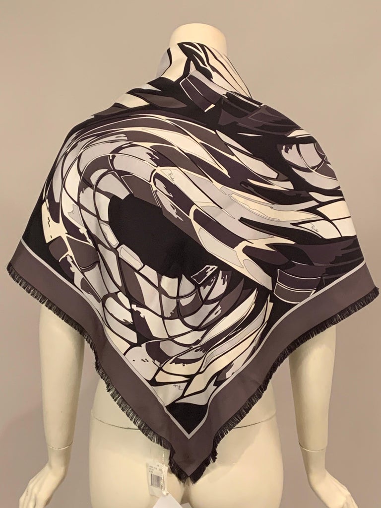This striking Emilio Pucci silk scarf in black and white and shades of grey has a black fringe on all four sides. The scarf is signed within the design, it also has a silk label and the original hang tags.  It is in excellent