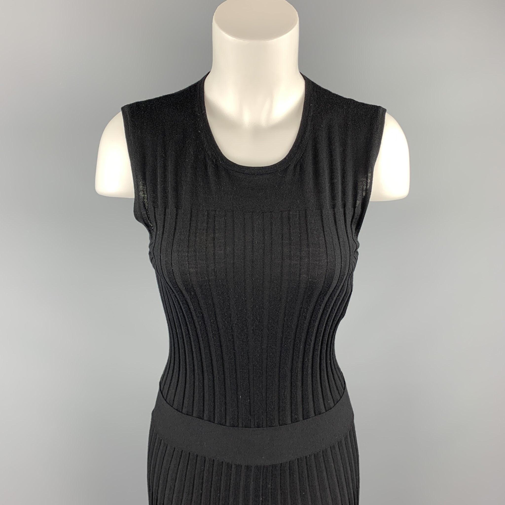 EMILIO PUCCI sleeveless dress comes in a black ribbed knit virgin wool with a fit to flair ruffled skirt and a crew-neck. Small hole. As-Is. Made in Italy.Good
Pre-Owned Condition. 

Marked:   L 

Measurements: 
 
Shoulder: 13.5 inches 
Bust: 26