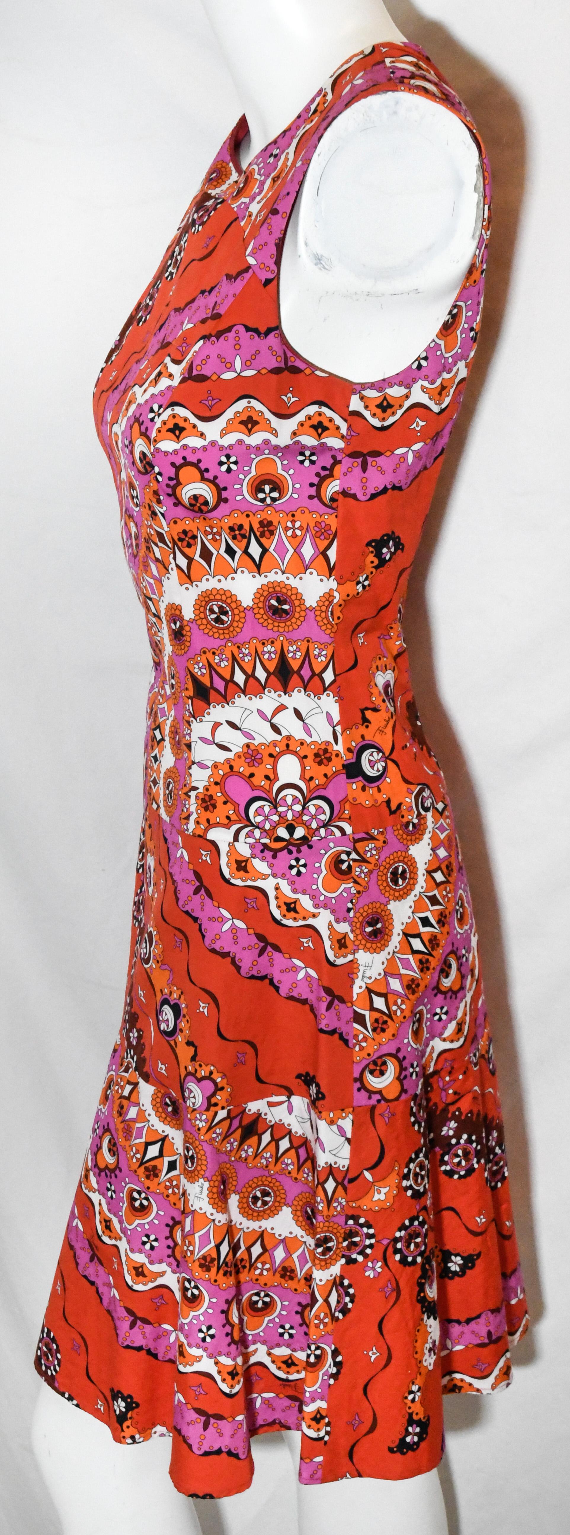 Emilio Pucci vibrant red print round neck dress includes a long gold tone zipper at back.  This dress is tapered to the body down to the hips then dress opens up to the hem.  This dress is not lined.  Dress is in excellent condition.  Made in Italy