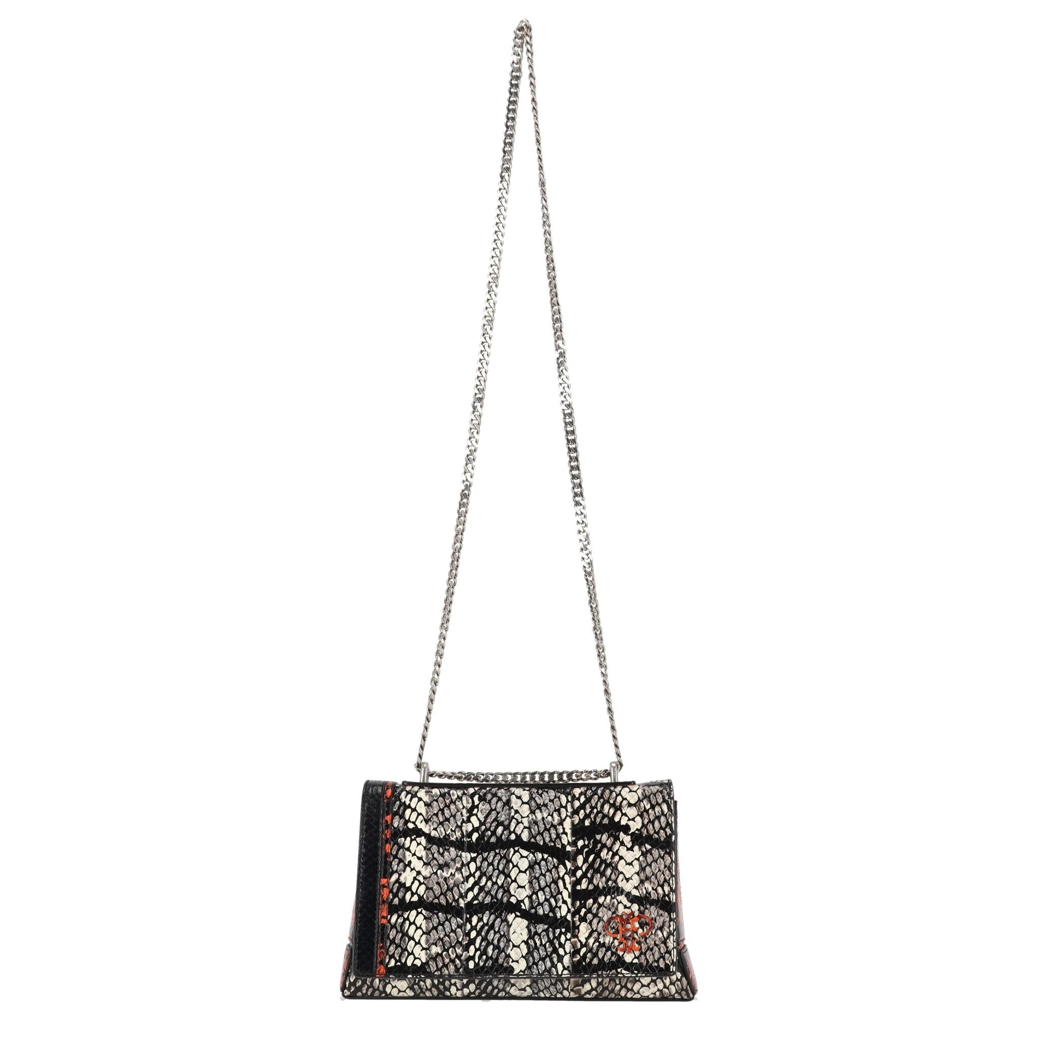 Emilio Pucci Snakeskin Crossbody Bag

Black and white exotic leather bag with contrast orange accents.

Designed with front magnetic flap and orange logo detail to the front.

Featuring silver chain link shoulder strap and black interior with zipped