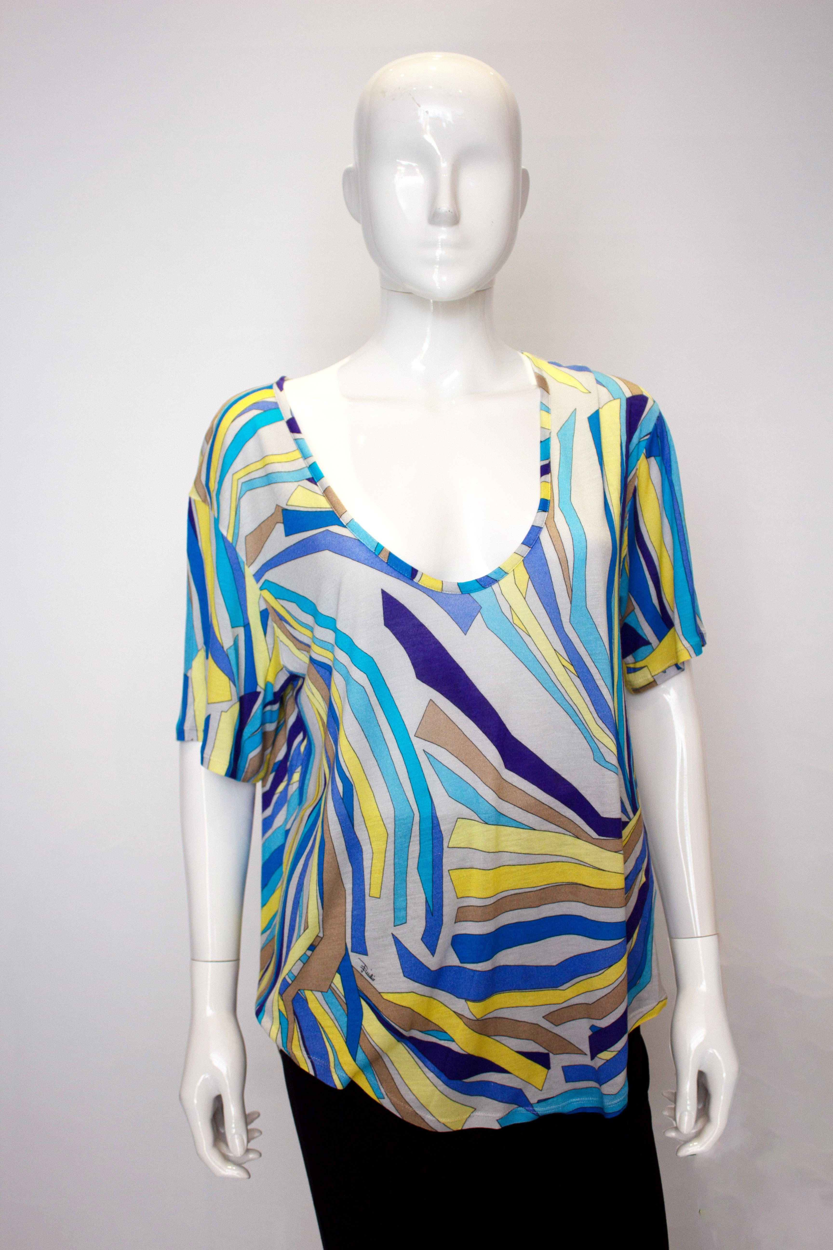 A fun and easy to wear Summer top by Pucci. In a silk mix knit the top is in a wonderful grey, yellow and blue print with a deep round neckline.