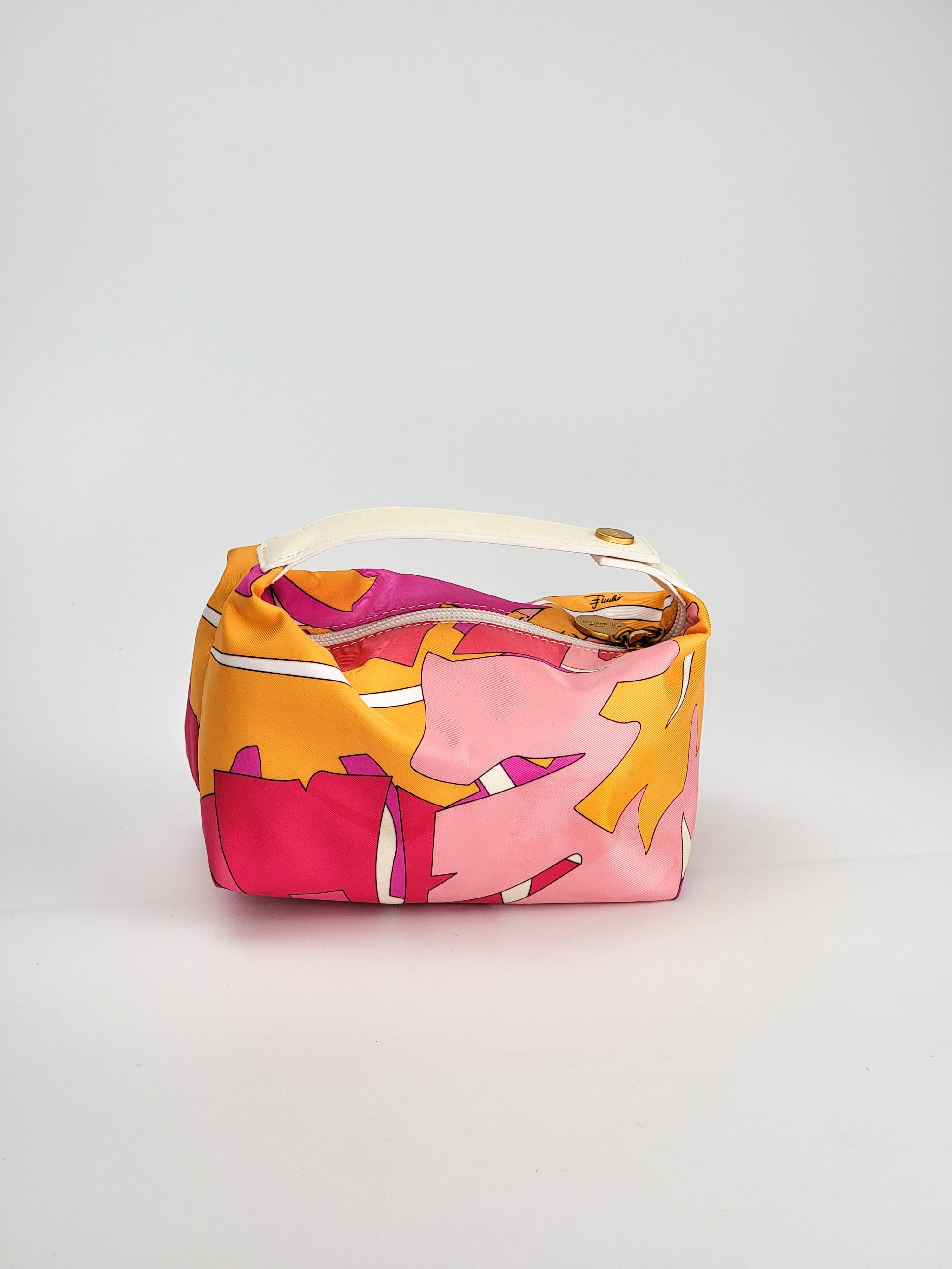 The most adorable Pucci bag :) This mini bag features gold tone hardware and an iconic Pucci abstract design in purples, pinks, yellow and white. Includes a white leather top handle with a gold tone snap closure signed 