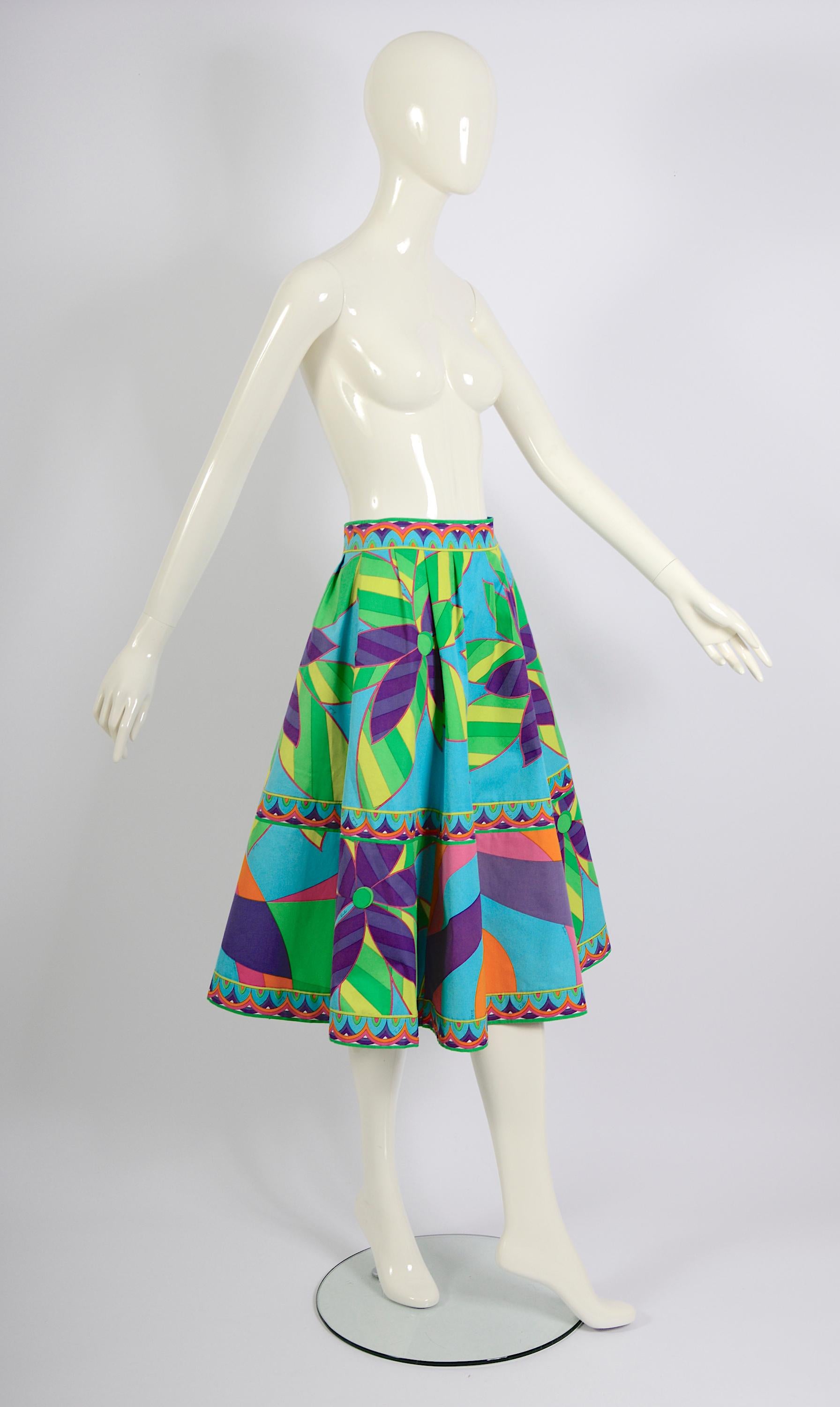 The ideal holiday skirt. A rare 1960s flower print circle  skirt by Emilio Pucci crafted in pure cotton. The skirt has a fitted waistband and pleats at the front and back The pattern features a geometric swirl design in shades of aqua blue, purple,