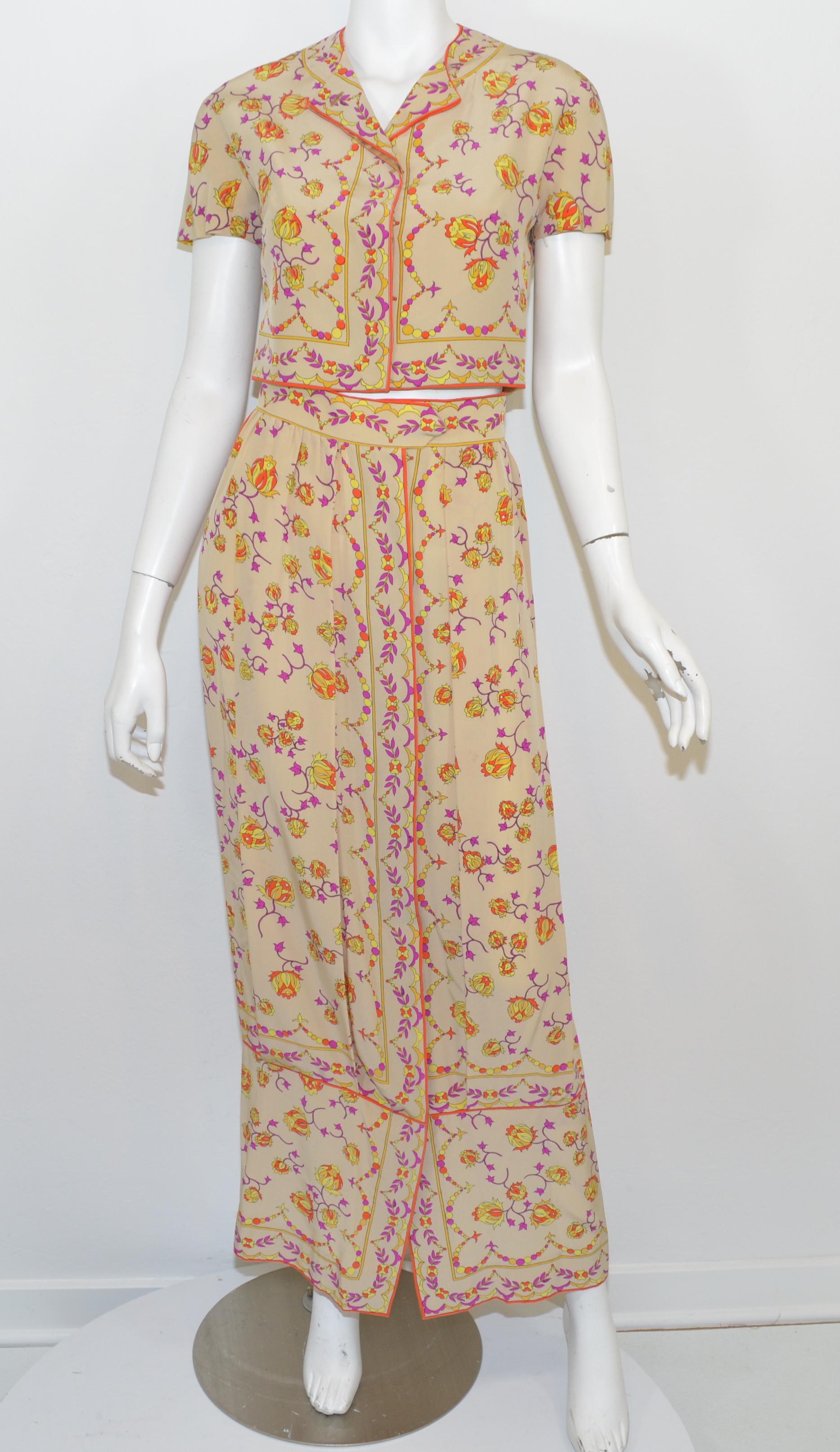 Vintage Emilio Pucci skirt set featured a floral print along a beige background. Top is cropped and has concealed button closures. Skirt has a drop waist style and a full button front closure. 

Measurements:
Top - bust 36'', length 16''
Skirt  -