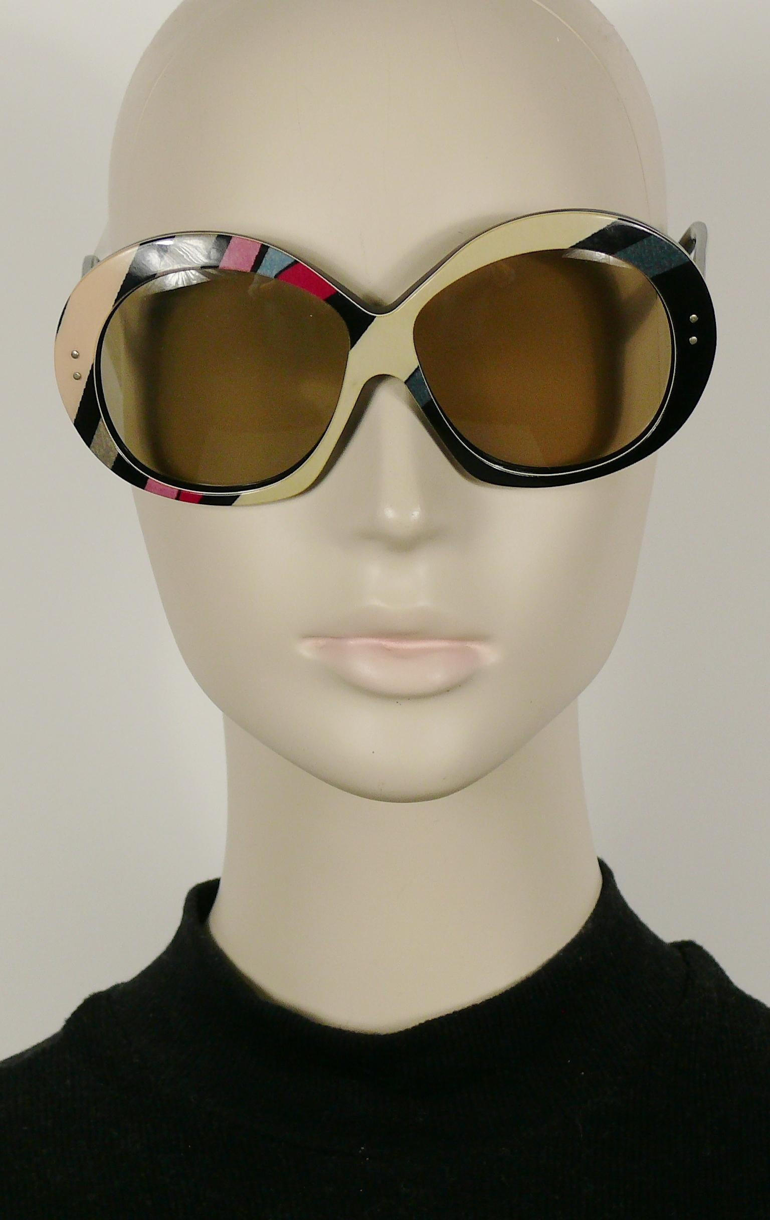 EMILIO PUCCI vintage oversized sunglasses featuring the iconic EMILIO PUCCI psychedelic print in shades of beige, grey, pink, purple and black.

A similar model was worn by ISABELLA ROSSELLINI for VOGUE ITALIA.

Original plastic tinted