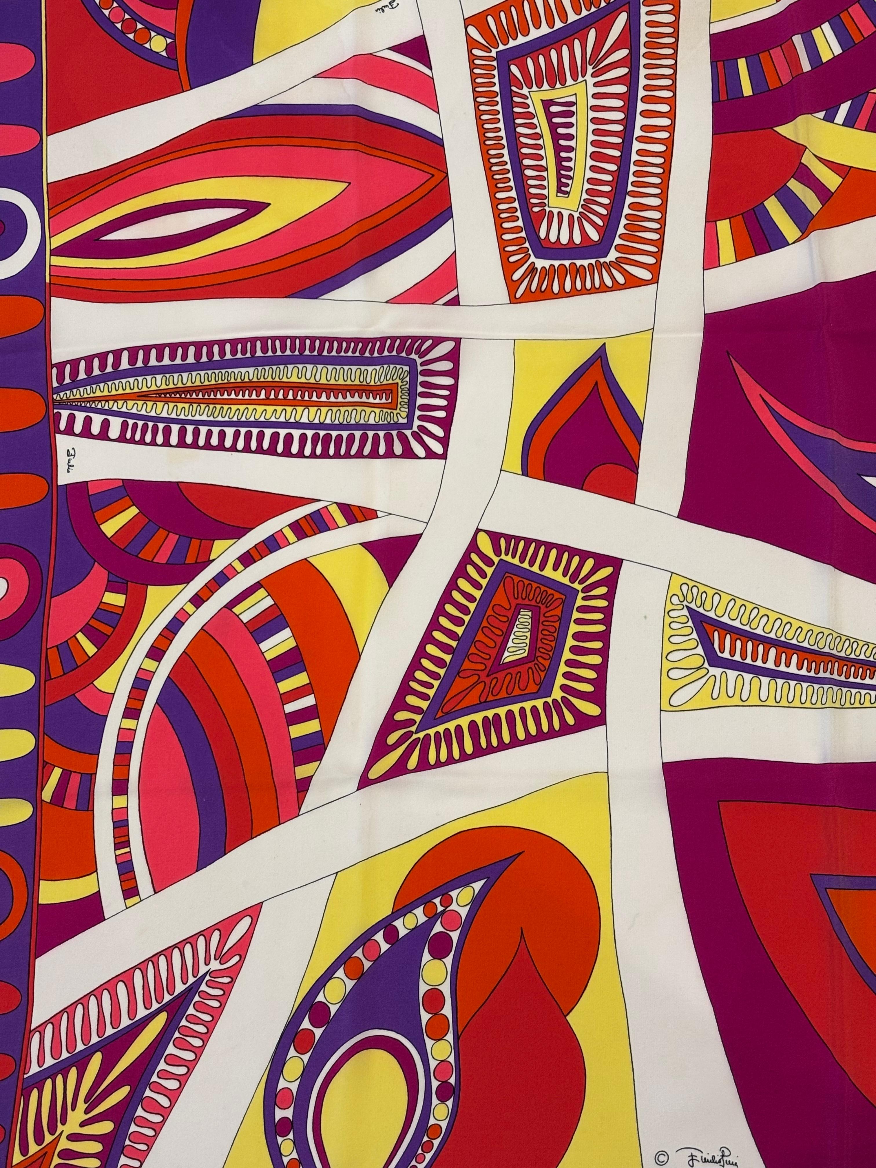 Such a colourful and vivid  Emilio Pucci silk scarf. The dominant colours are purple, yellow, orange, red, and cream. This Pucci scarf is in great condition apart from a small discoloured spot. The design is a variation of abstract motifs. The silk