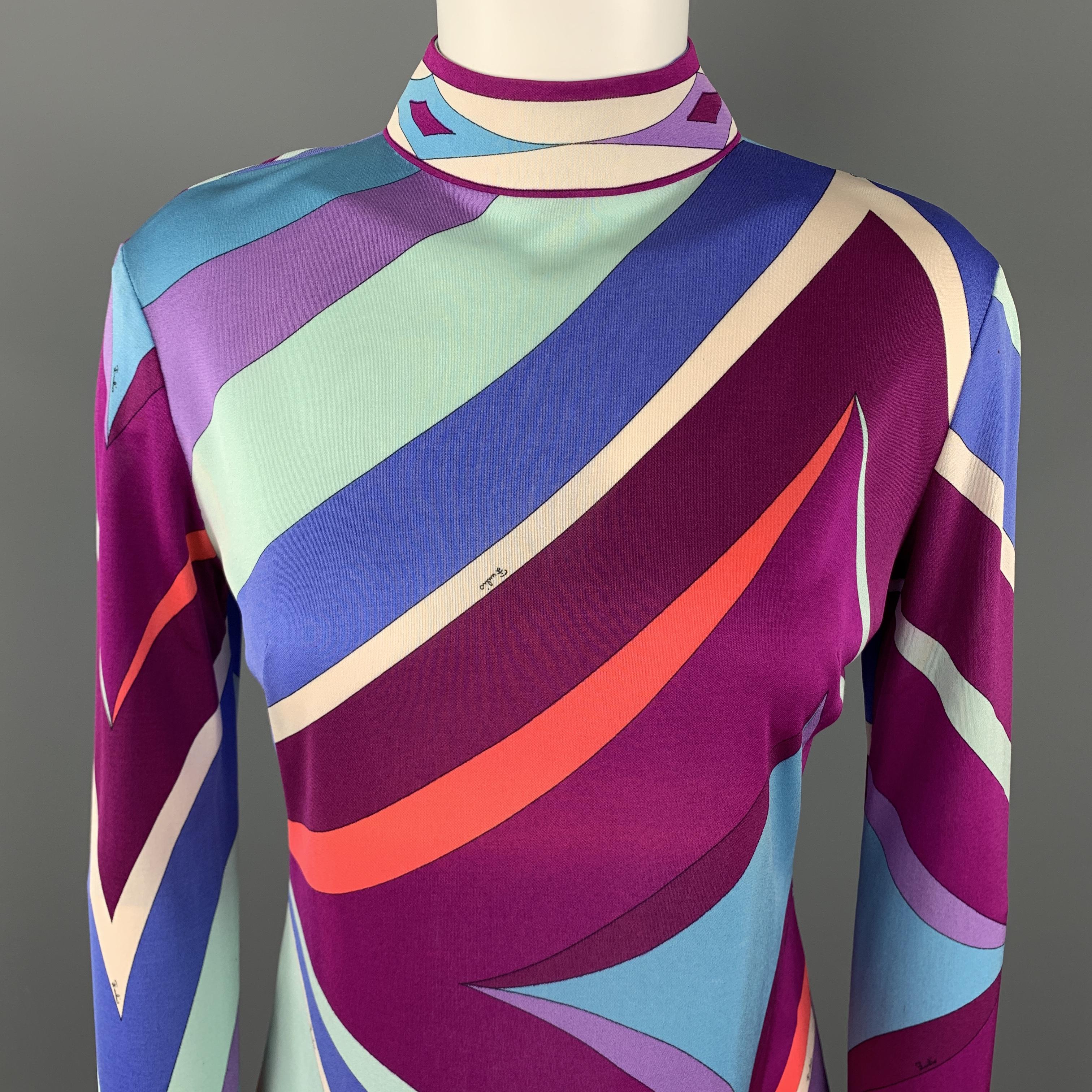 Vintage EMILIO PUCCI blouse comes in blue and purple print silk jersey with a mock neck and back zip with placket. Fading throughout. As-is. Made in Italy.

Good Pre-Owned Condition.
Marked: 10

Measurements:

Shoulder: 16.5 in,
Bust: 37 in.
Sleeve: