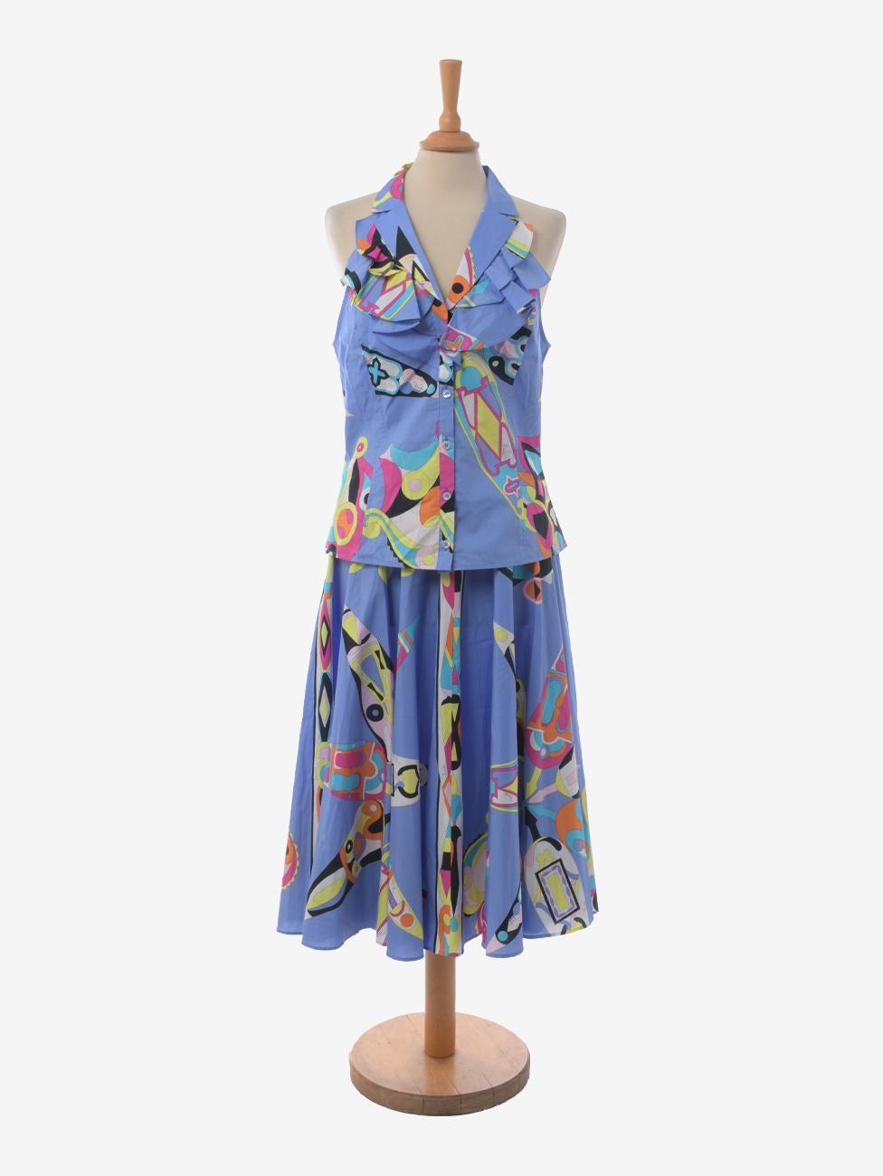 Emilio Pucci Vintage Suit is a two-piece ensemble featuring a button-front, v-neck top with ruffle collar and wide midi skirt with button and uncle back closure.The ensemble is decorated with Pucci's iconic multicolor pattern on an indigo