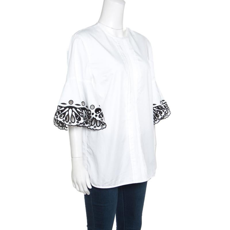 Elegant and stylish, this blouse from Emilio Pucci is sure to fetch you never ending compliments! The white creation is made of 100% cotton and features a round neckline, a pintuck detailing on the front and short sleeves with artistic Sangallo