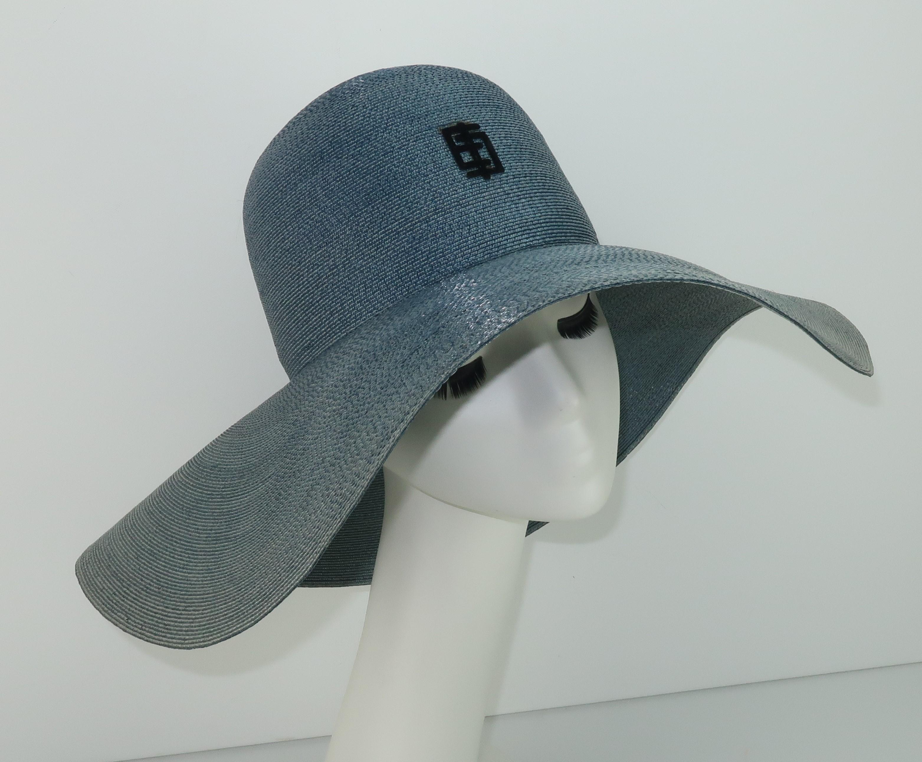 1960's Emilio Pucci floppy wide brim straw hat in a blue-gray shade reminiscent of denim with black velvet stylized 'EP' logo at the crown.  The chic floppy style is perfect for sun shade or traveling incognito.  Originally retailed at Saks Fifth