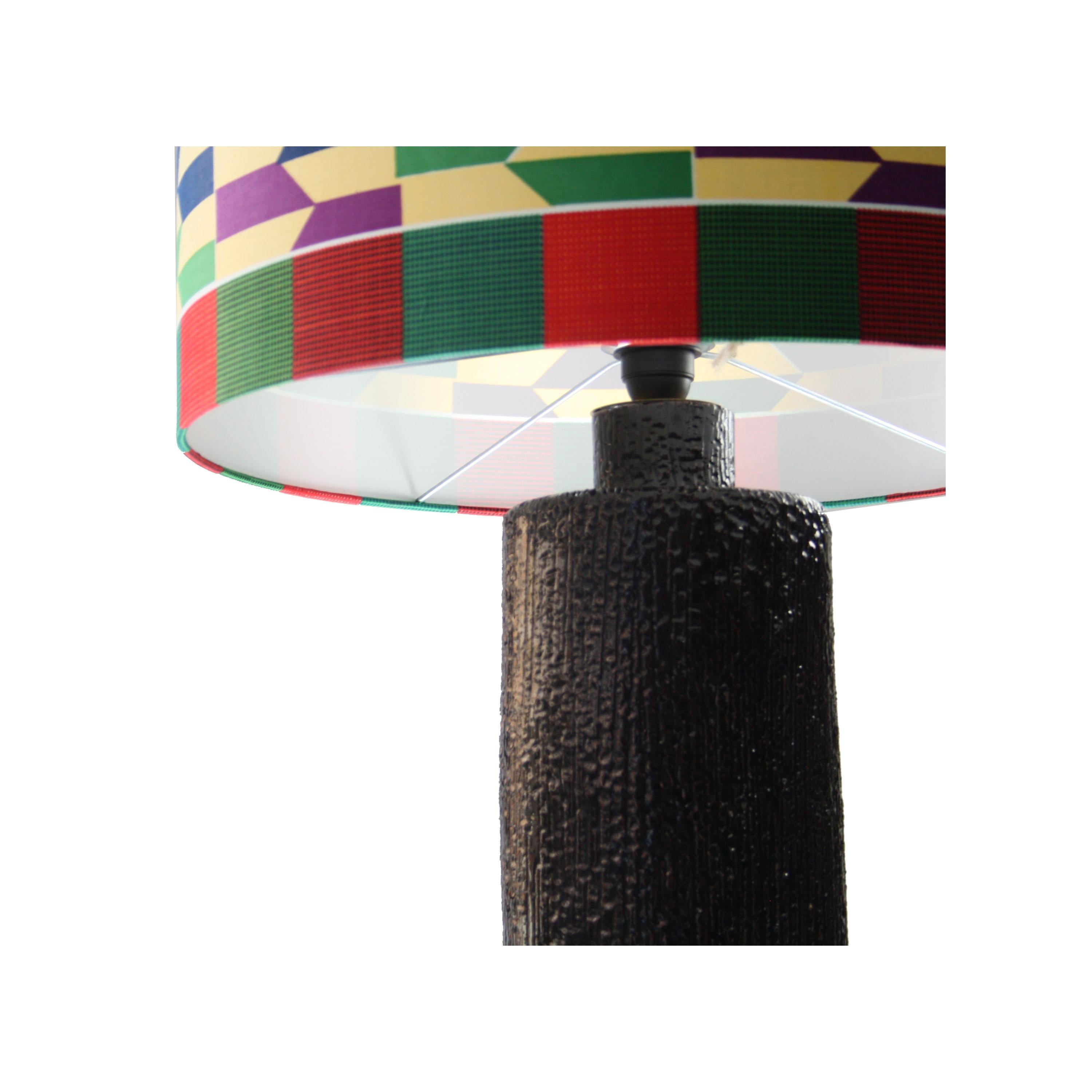 Cylindrical lamp designed by Emilio Rey, with black handmade ceramic base and lampshade in Kitenge fabric. Piece made to order in 1950.