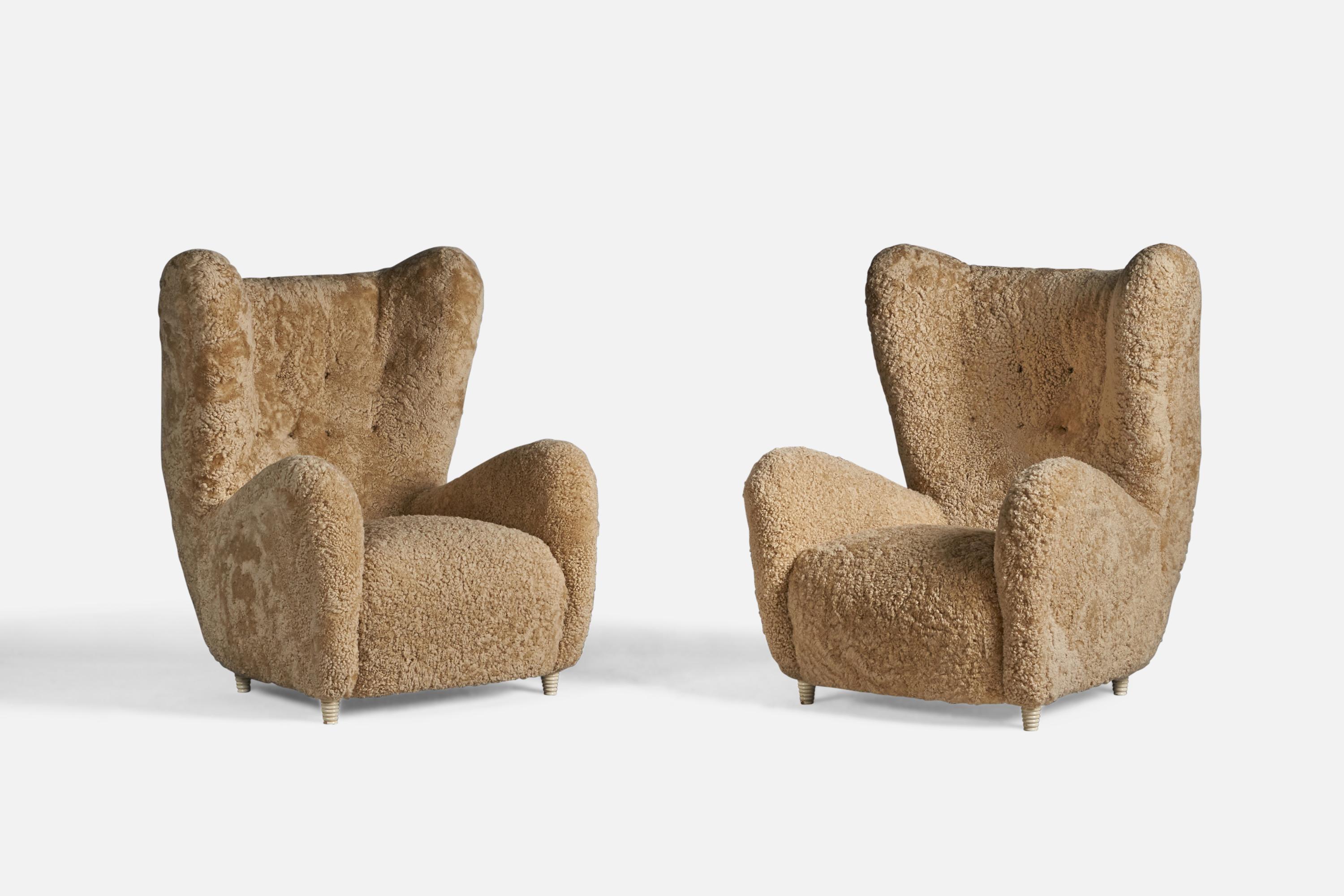 A pair of sizeable organic beige shearling and off-white lacquered wood lounge chairs, designed and produced by Emilio Sarrachi, Milan, Italy, c. 1940s. 

With makers paper label to wooden frame.

19
