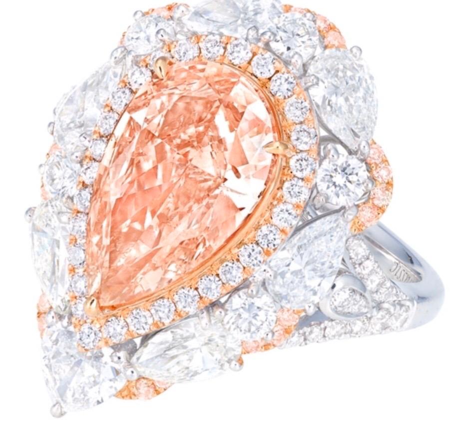 Showcasing a very special certified 3 carat clean natural fancy orange pink diamond in the center, certified by GIA. Pink the the primary color according to GIA and orange is the overtone. Hand made in the Emilio Jewelry Atelier, whom specializes in