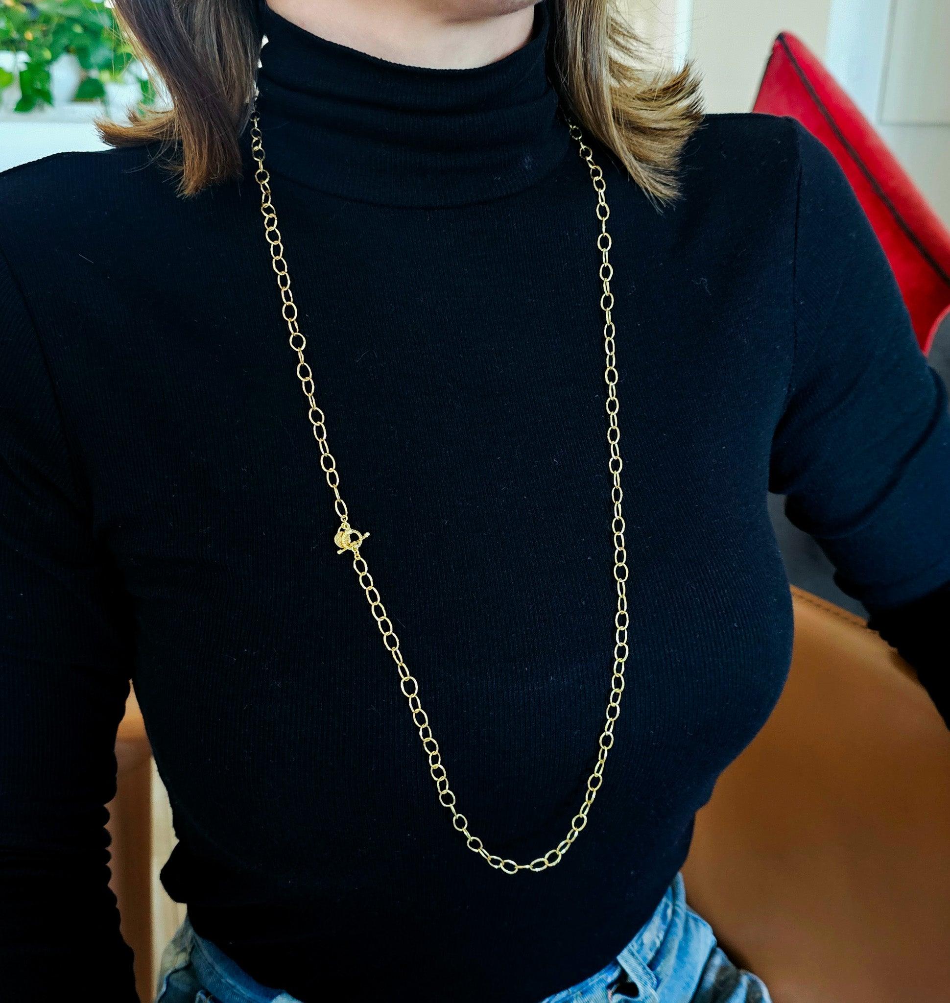 A naïve chain designed by Emily Armenta.

This is a beautiful long chain, created by Emily Armenta in solid yellow gold of 18 karats, with hammered naïve finish. This sautoir chain has a very casual informal look and is fitted with a discreet toggle
