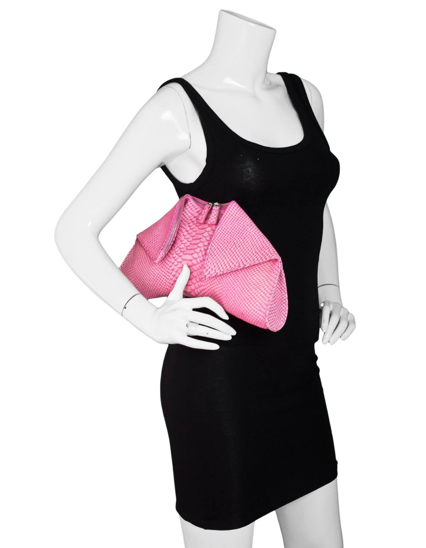 Emily Cho Pink Embossed Snakeskin Folded Clutch

Made In: China
Color: Pink
Hardware: Silvertone
Materials: Embossed leather, metal
Lining: Pink textile
Closure/Opening: Fold-over sides with double zip top
Exterior Pockets: None
Interior Pockets:
