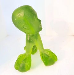 Baby Face on Claw Foot Base: green glass sculpture, surrealism / pop art child