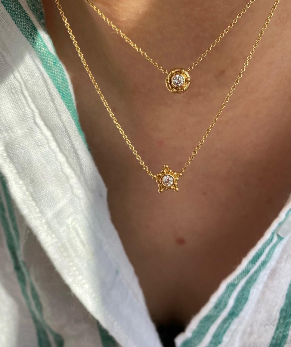 The Granium Star Necklace features a diamond set into a star shaped pool of golden spheres. Imagine this star as a corner of a constellation, one of the many distant places we have yet to explore and understand. The significance of constellations