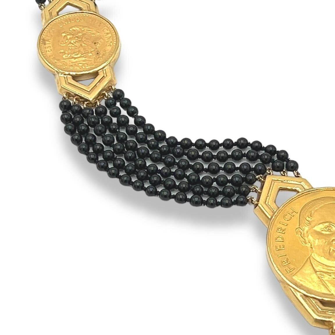 An 18 karat yellow gold and high karat gold, black onyx and diamond necklace, Emis Beros, circa 1970s.  Designed as a six (6) strand necklace of black onyx beads punctuated with six (6) graduated gold coins from various nations set within gold