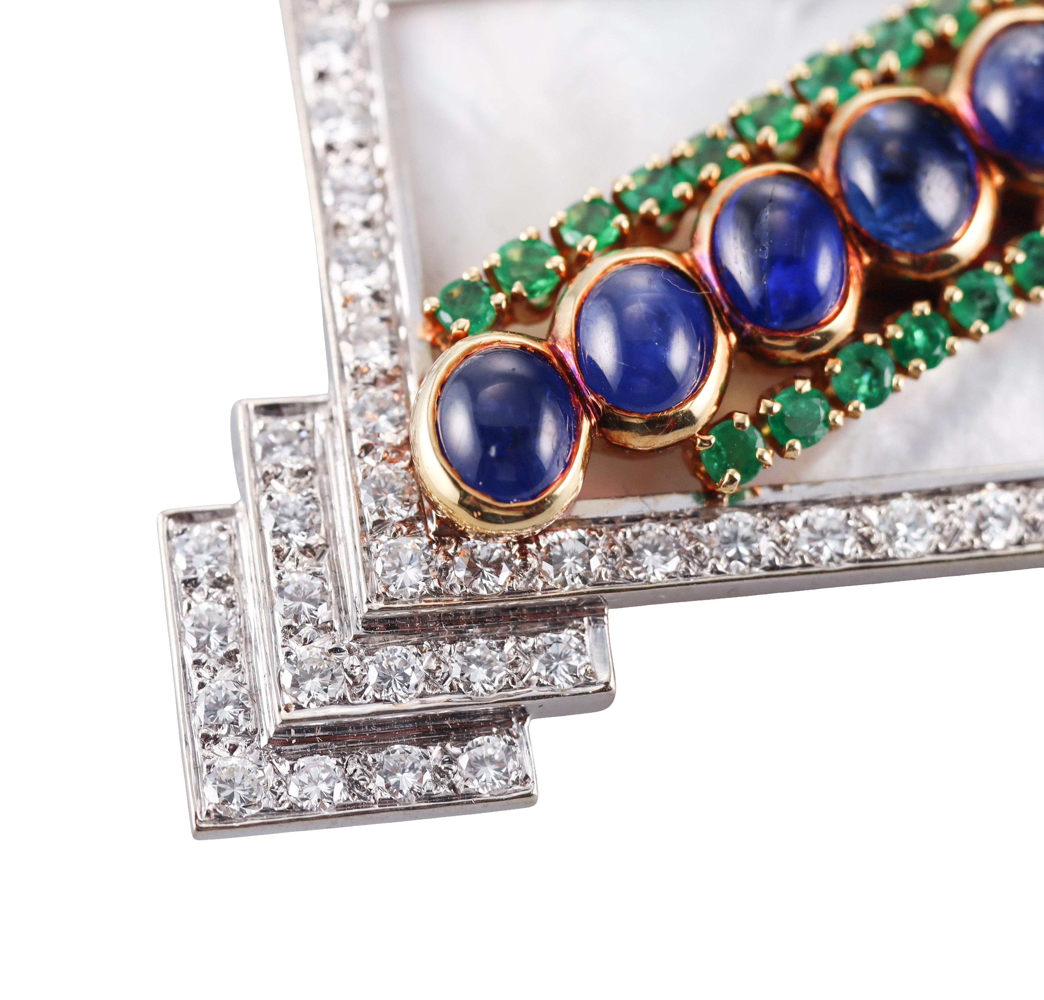 An 18k yellow and white gold brooch by Emis, featuring emeralds, mother of pearl, sapphire cabochons and approx. 2.60ctw in H/VS diamonds.
Brooch measures 2.25